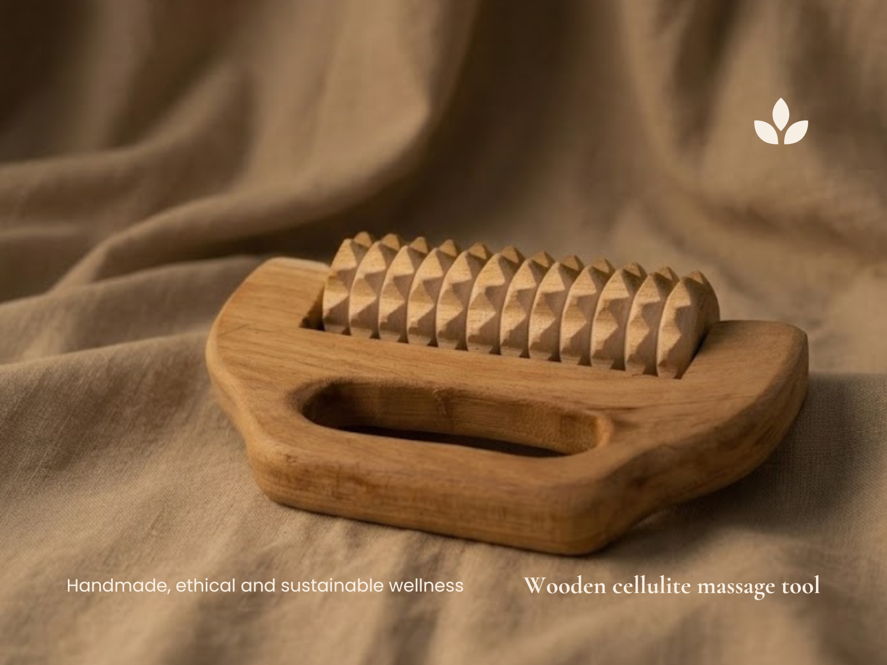 Handmade wooden cellulite massage tool on soft fabric with textured roller and natural wood handle