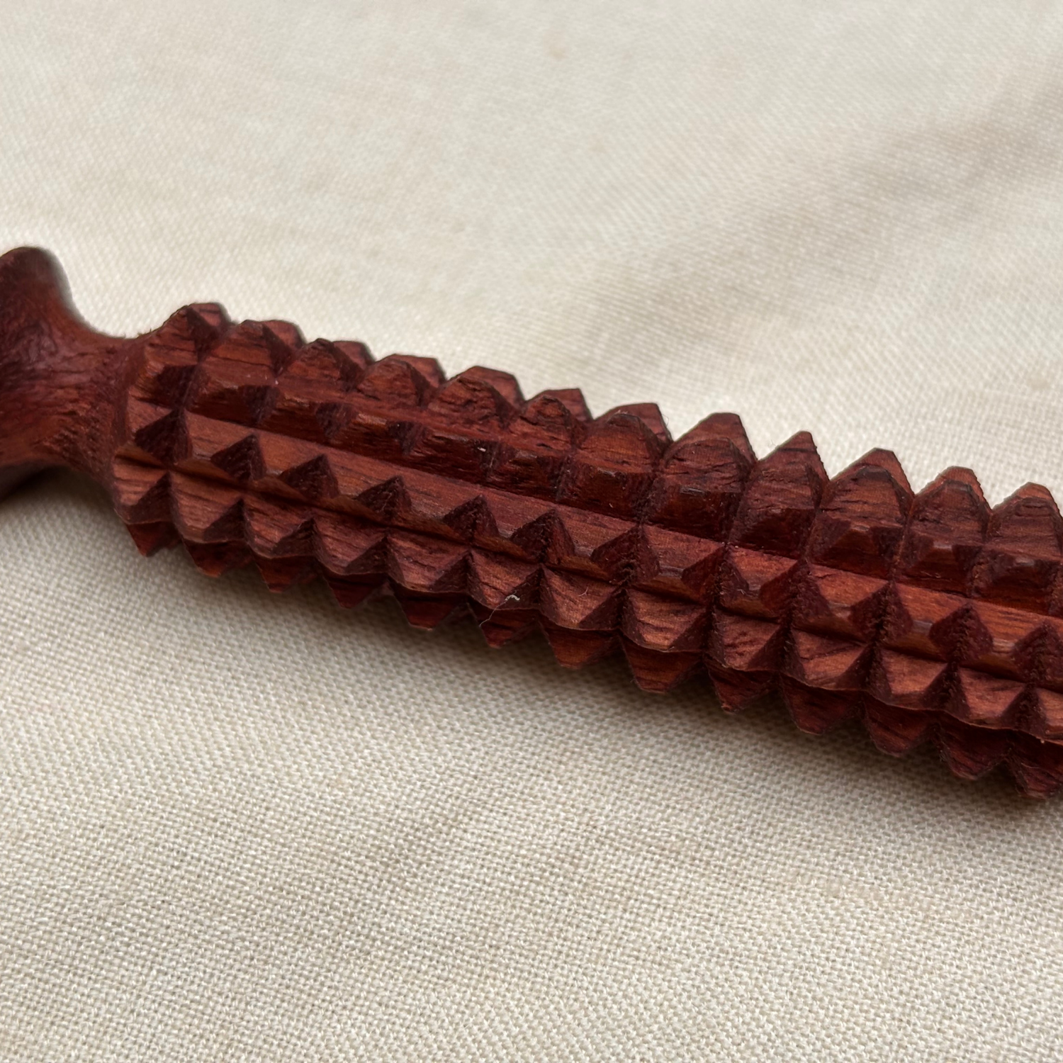 wooden-facial-acupressure-tool-texture-closeup.jpg.png