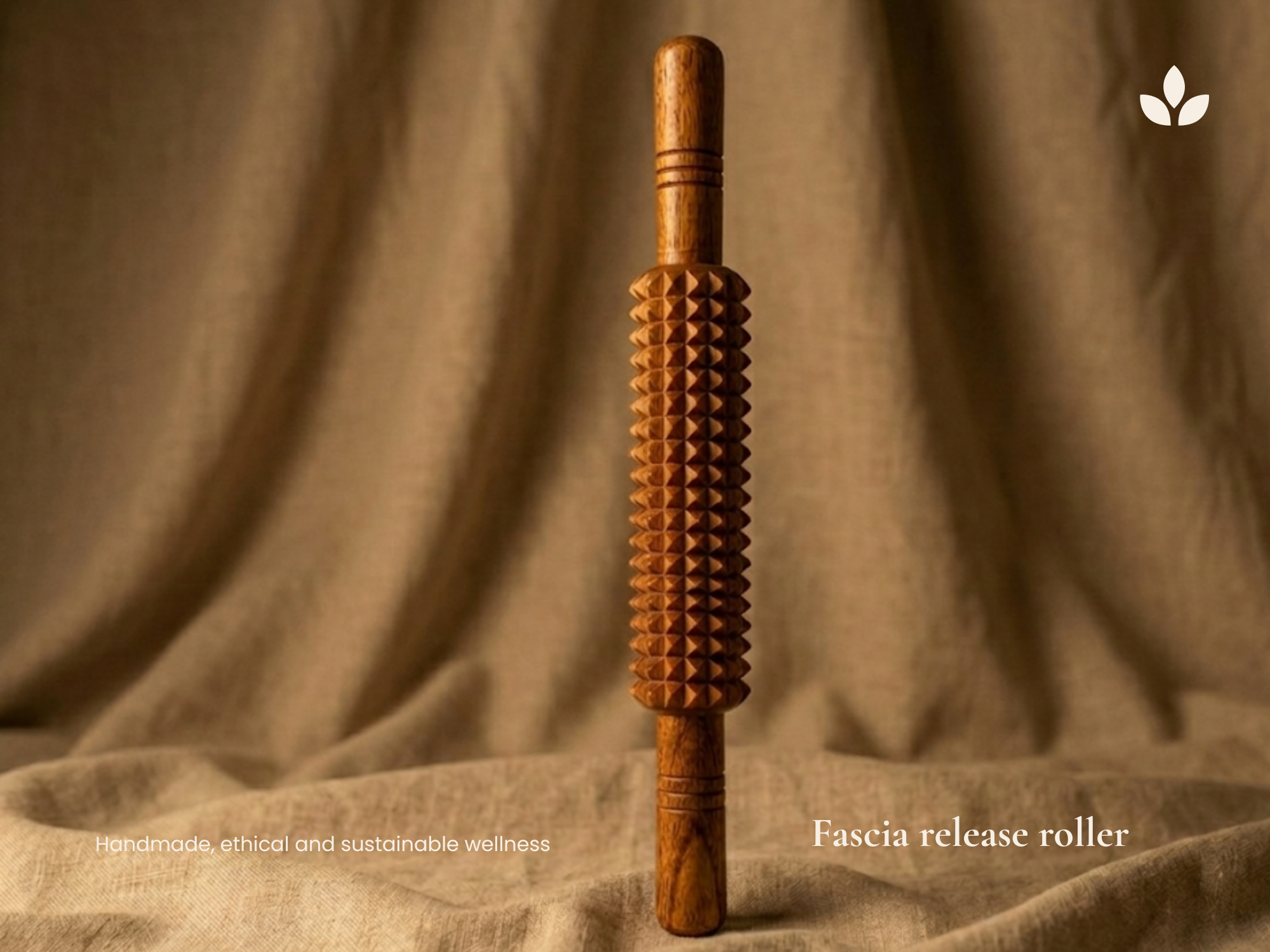 Handmade wooden muscle recovery roller displayed on linen fabric for natural fascia release and relaxation.