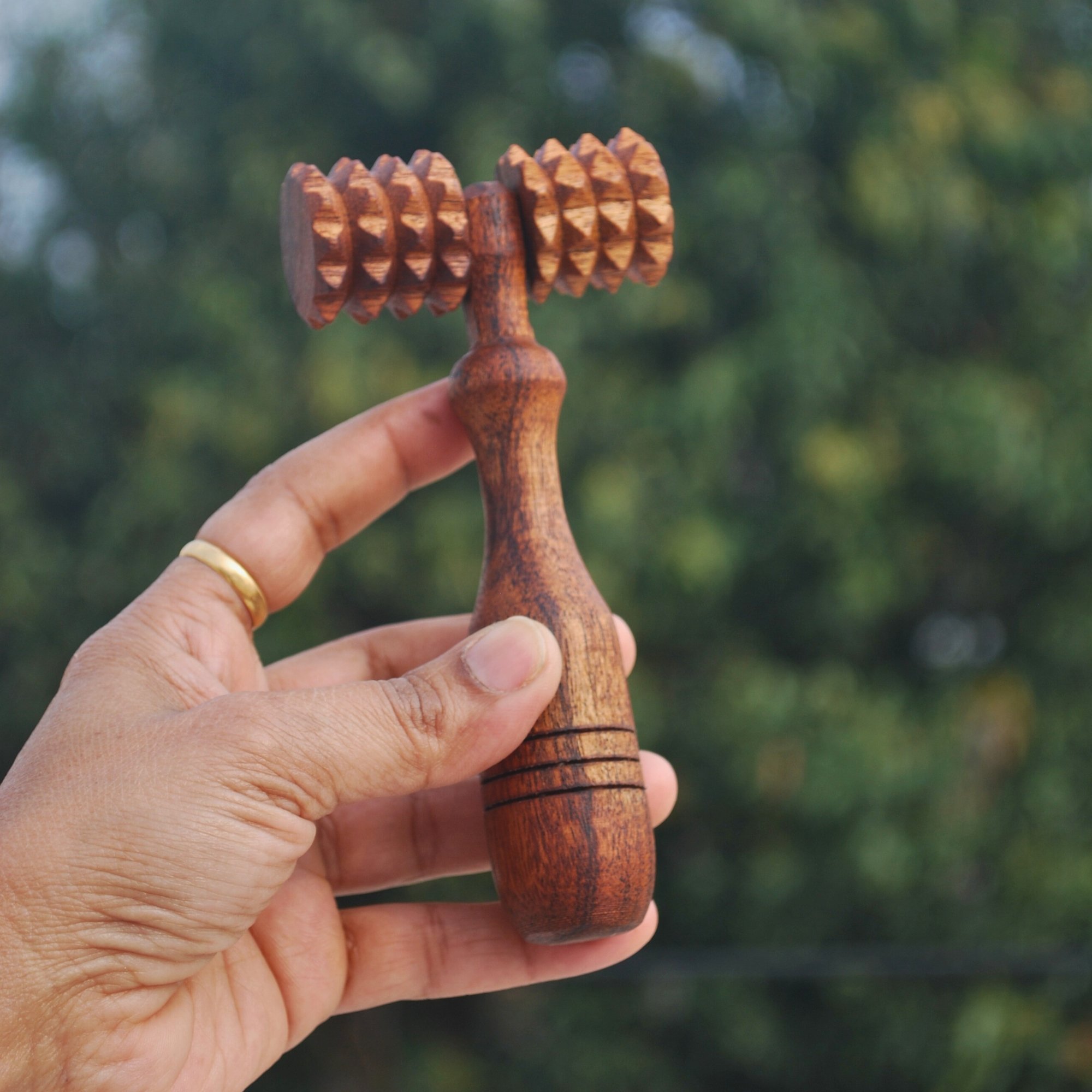 Wooden_deep_tissue_massage_roller_in_hand.jpg