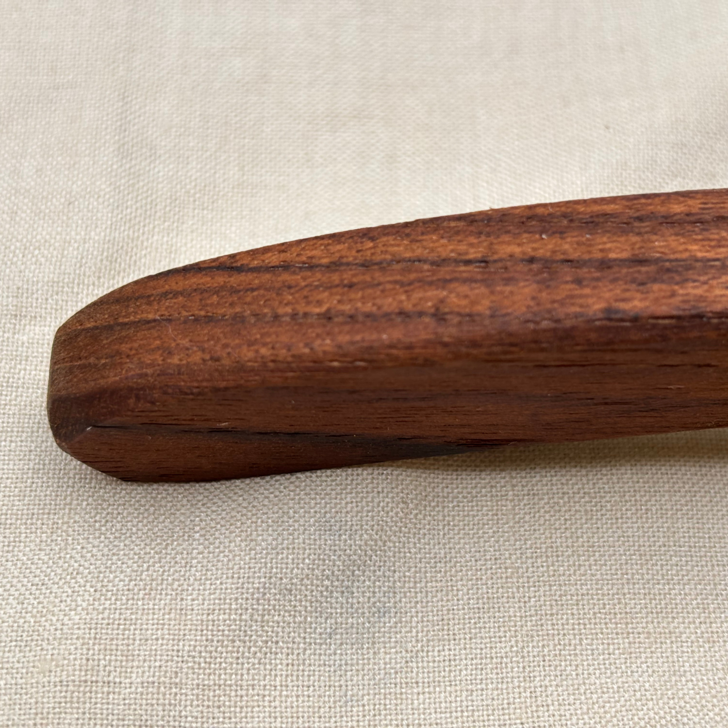 closeup of the curved handle of lymphatic face roller