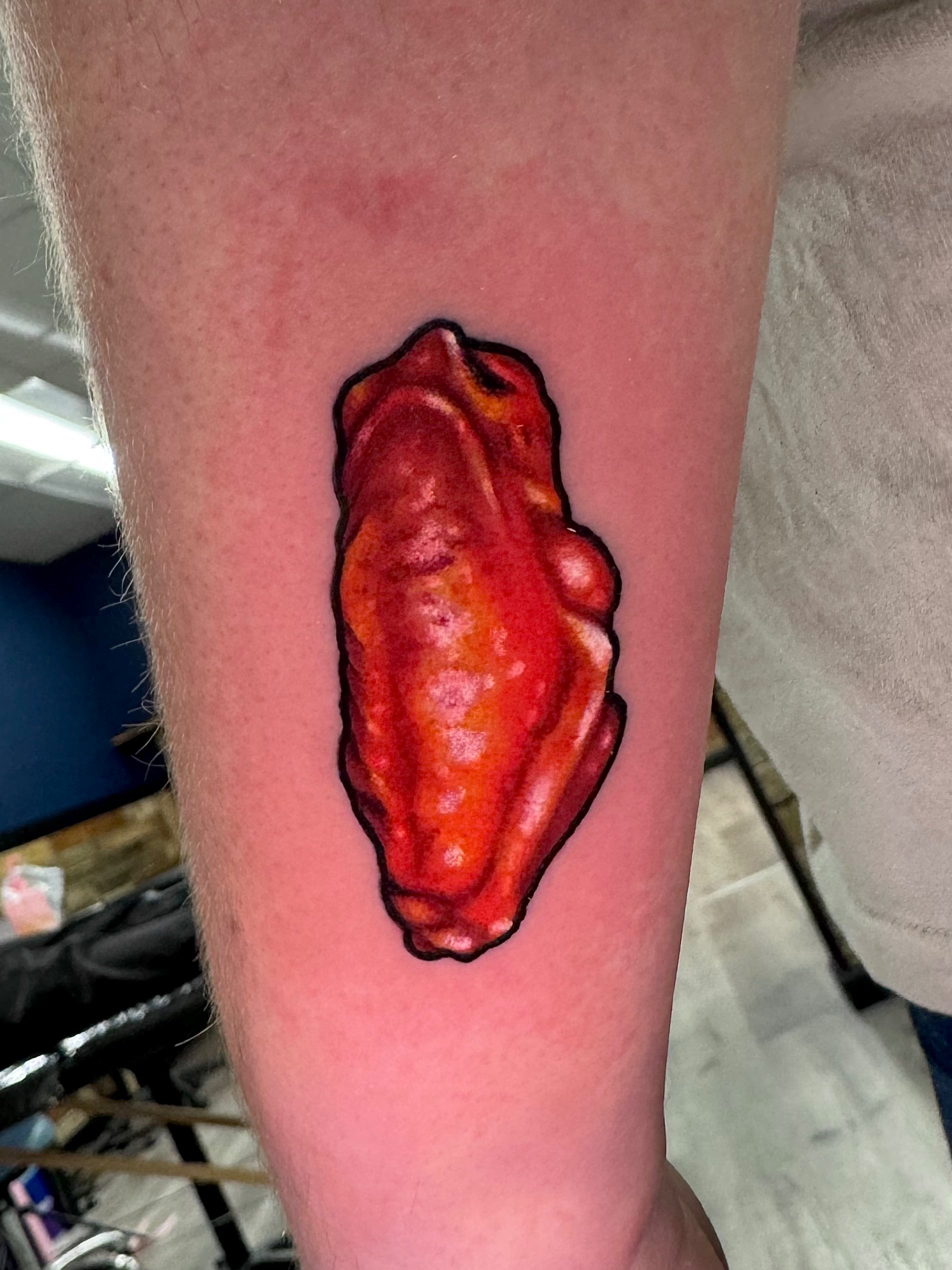 Realistic Buffalo chicken wing tattoo in color portfolio work by Keith Kuzara at Sink or Swim Tattoo and Piercing in Niagara Falls NY