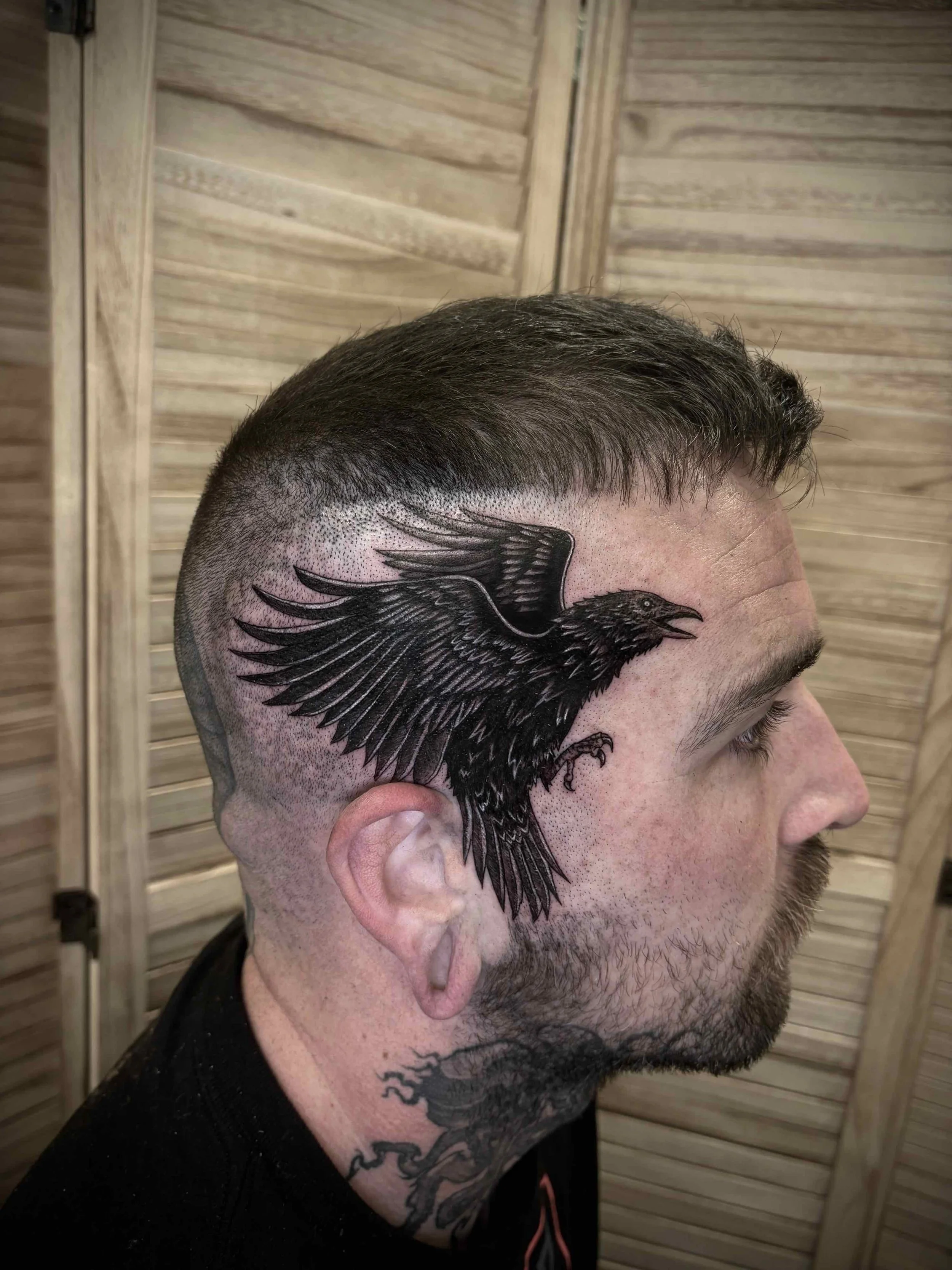 black work style raven tattoo on head , portfolio work by Brooke Canzoneri at sink or swim tattoo and piercing in Niagara Falls, ny