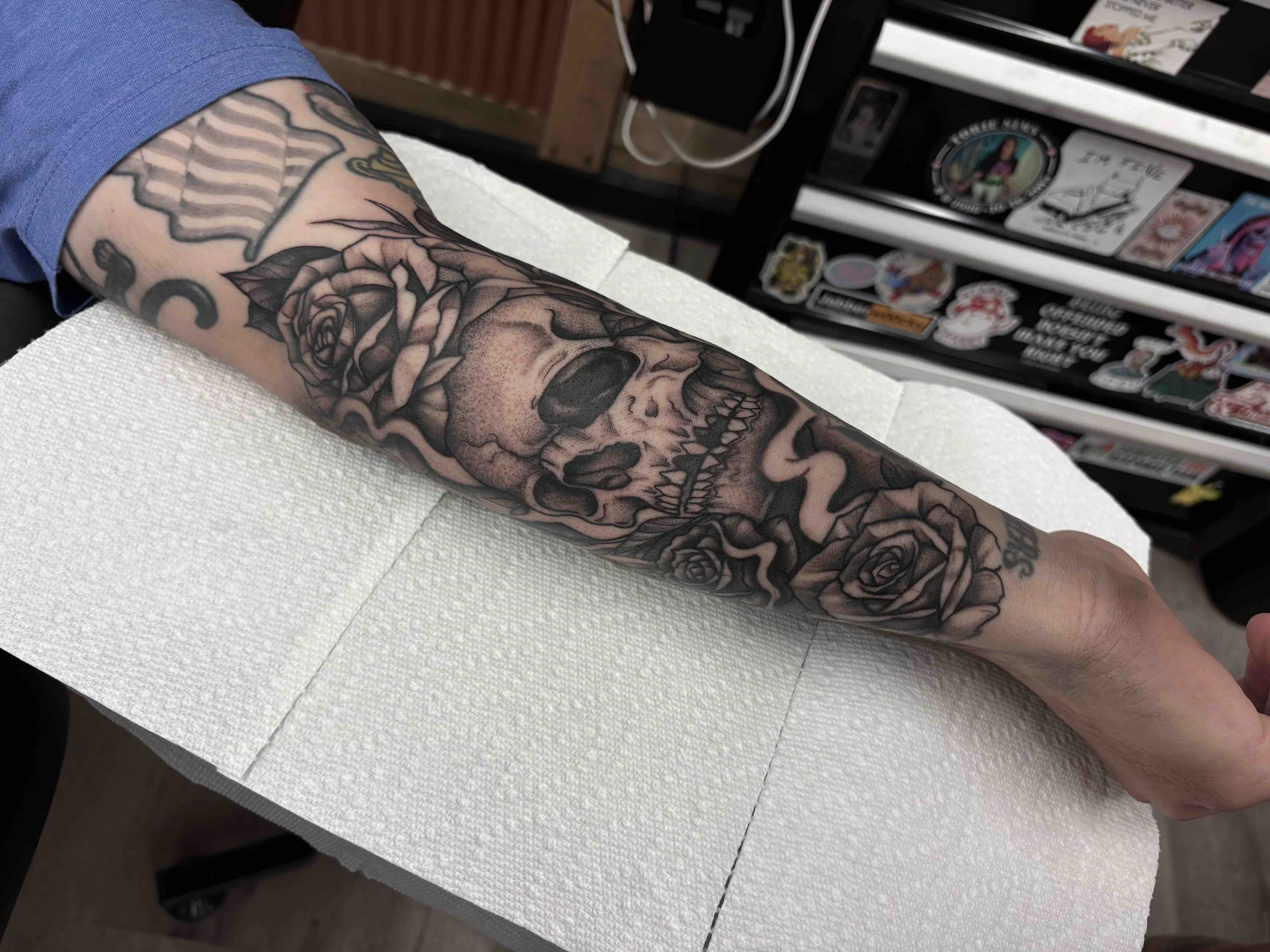black and grey, stipple shading skull and roses on forearm , portfolio work by Brooke Canzoneri at sink or swim tattoo and piercing in Niagara Falls, ny