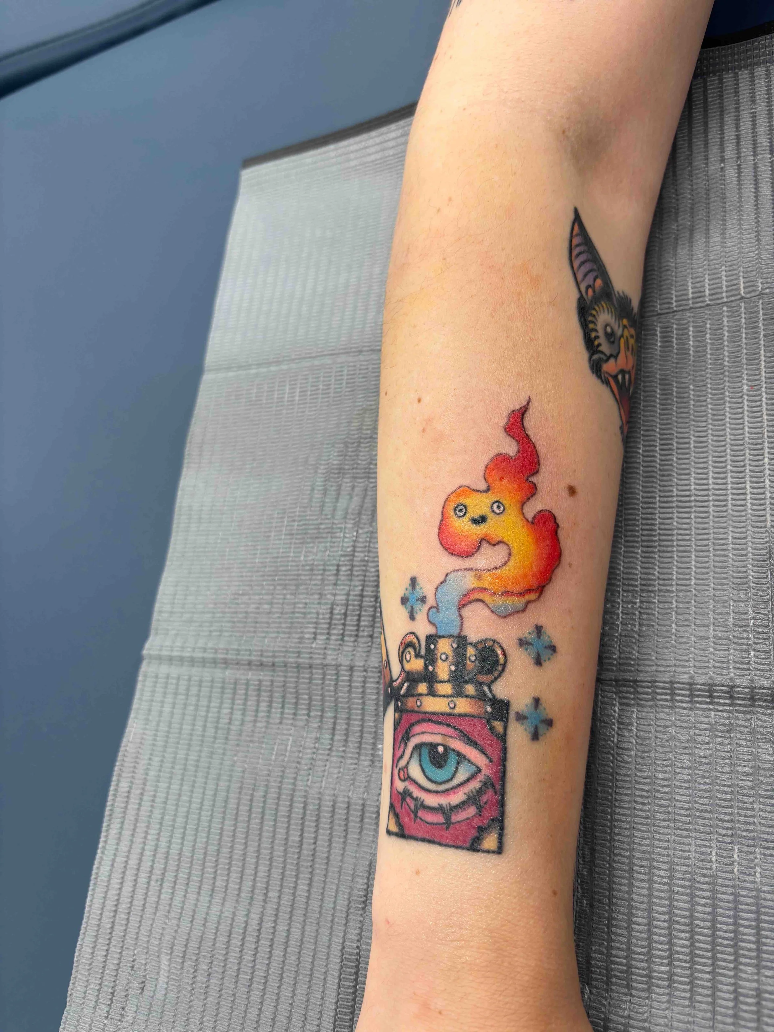 Neo traditional howls moving castle calcifer lighter color tattoo on forearm by AK Zaionz at Sink or Swim in Niagara Falls NY