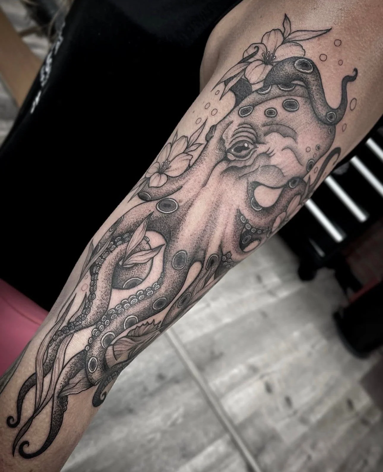 dot work style black and grey octopus tattoo on bicep , portfolio work by Brooke Canzoneri at sink or swim tattoo and piercing in Niagara Falls, ny