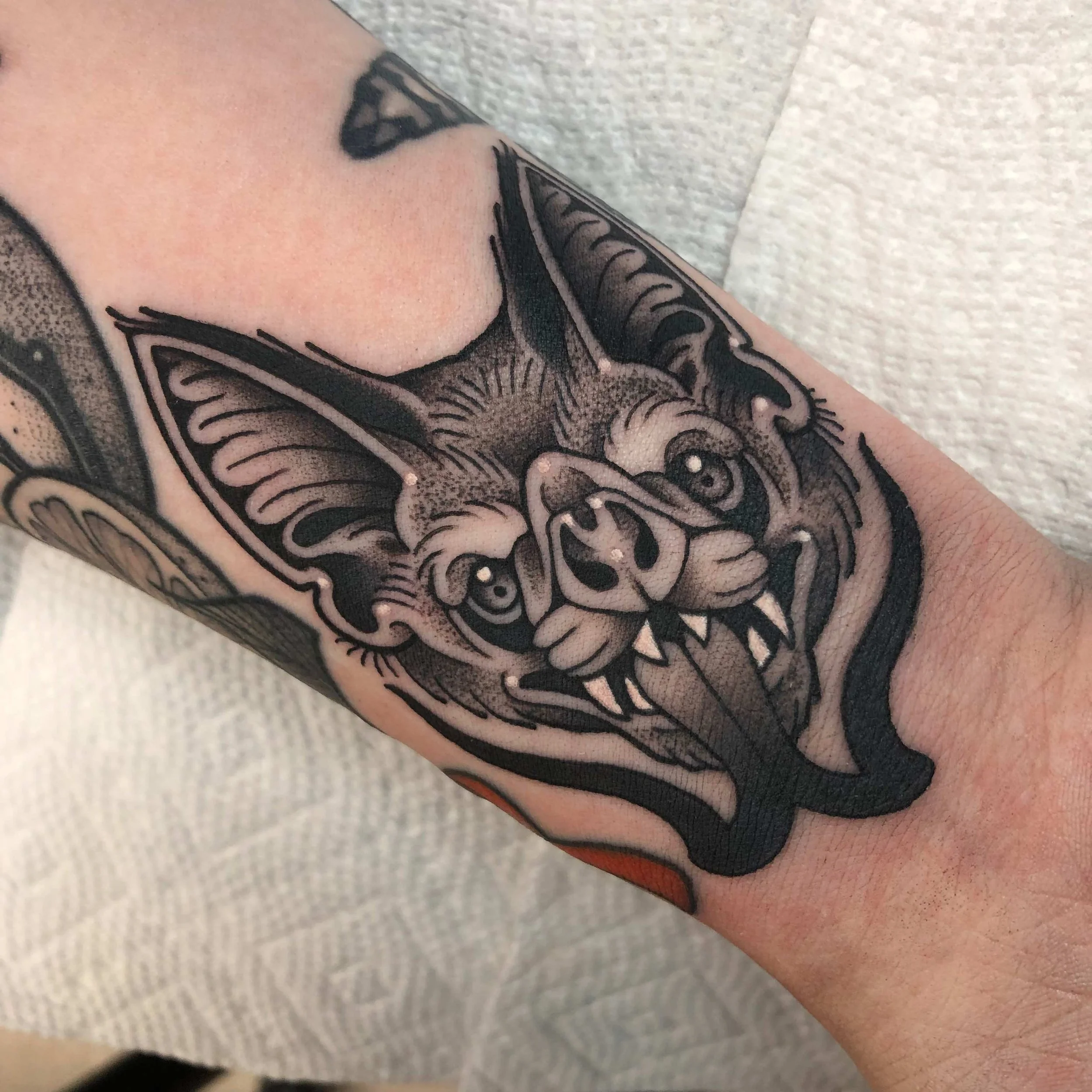 Traditional blackwork stippled bat head tattoo portfolio work by Keith Kuzara at Sink or Swim Tattoo and Piercing in Niagara Falls NY