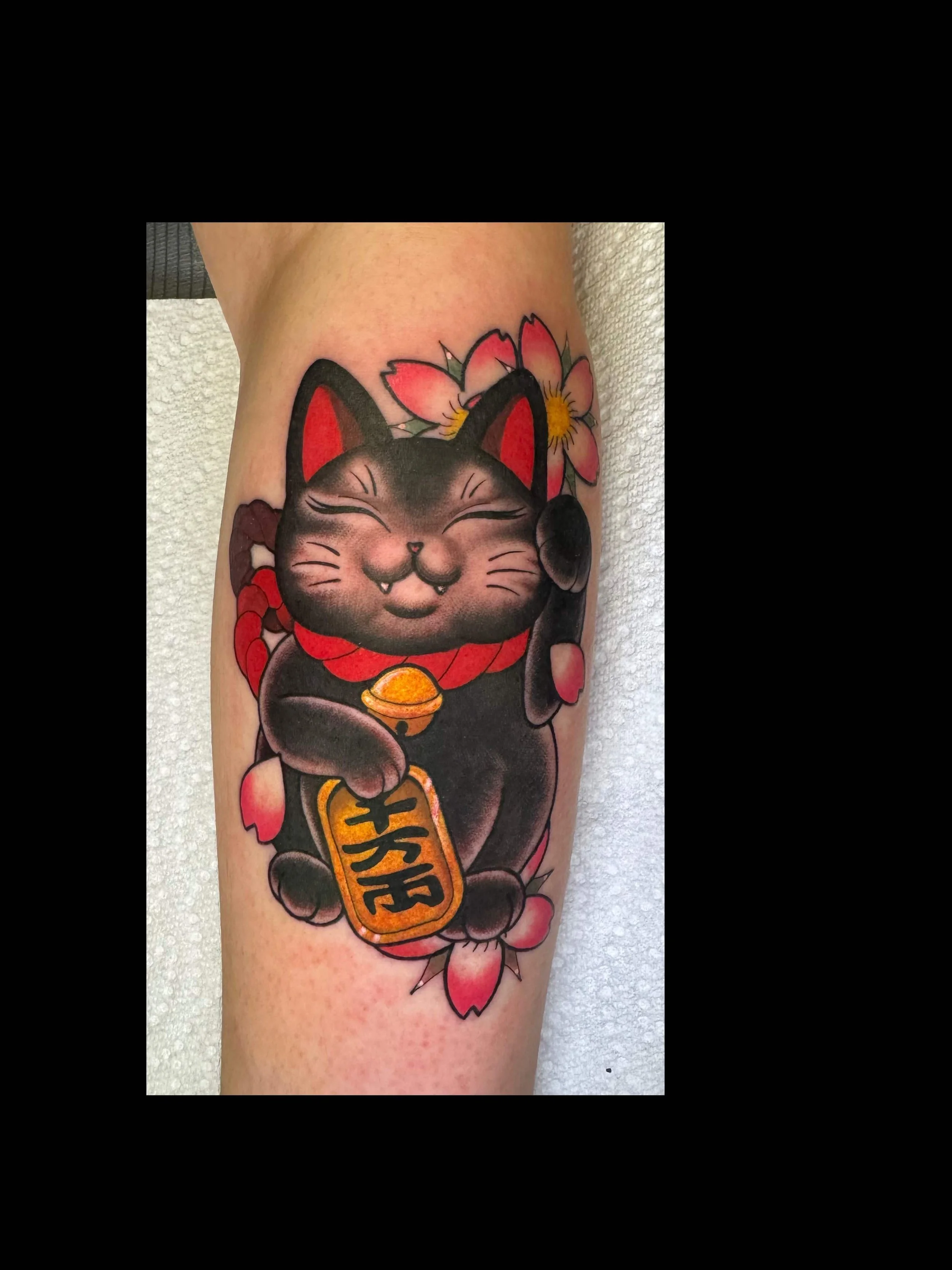 Japanese style lucky cat tattoo in color portfolio work by Shannon Kuzara at Sink or Swim Tattoo and Piercing in Niagara Falls NY
