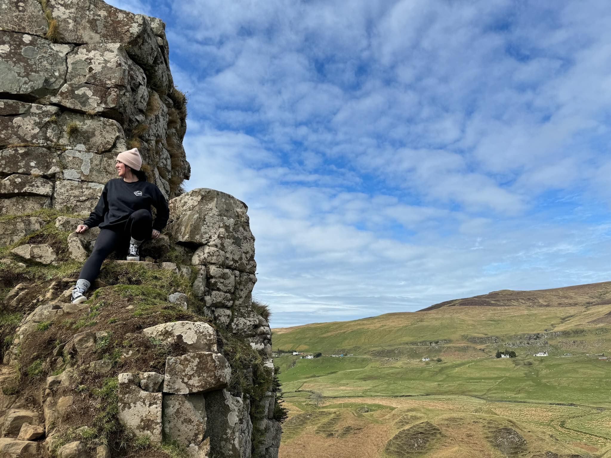 Shannon posing at a rock formation in scotland