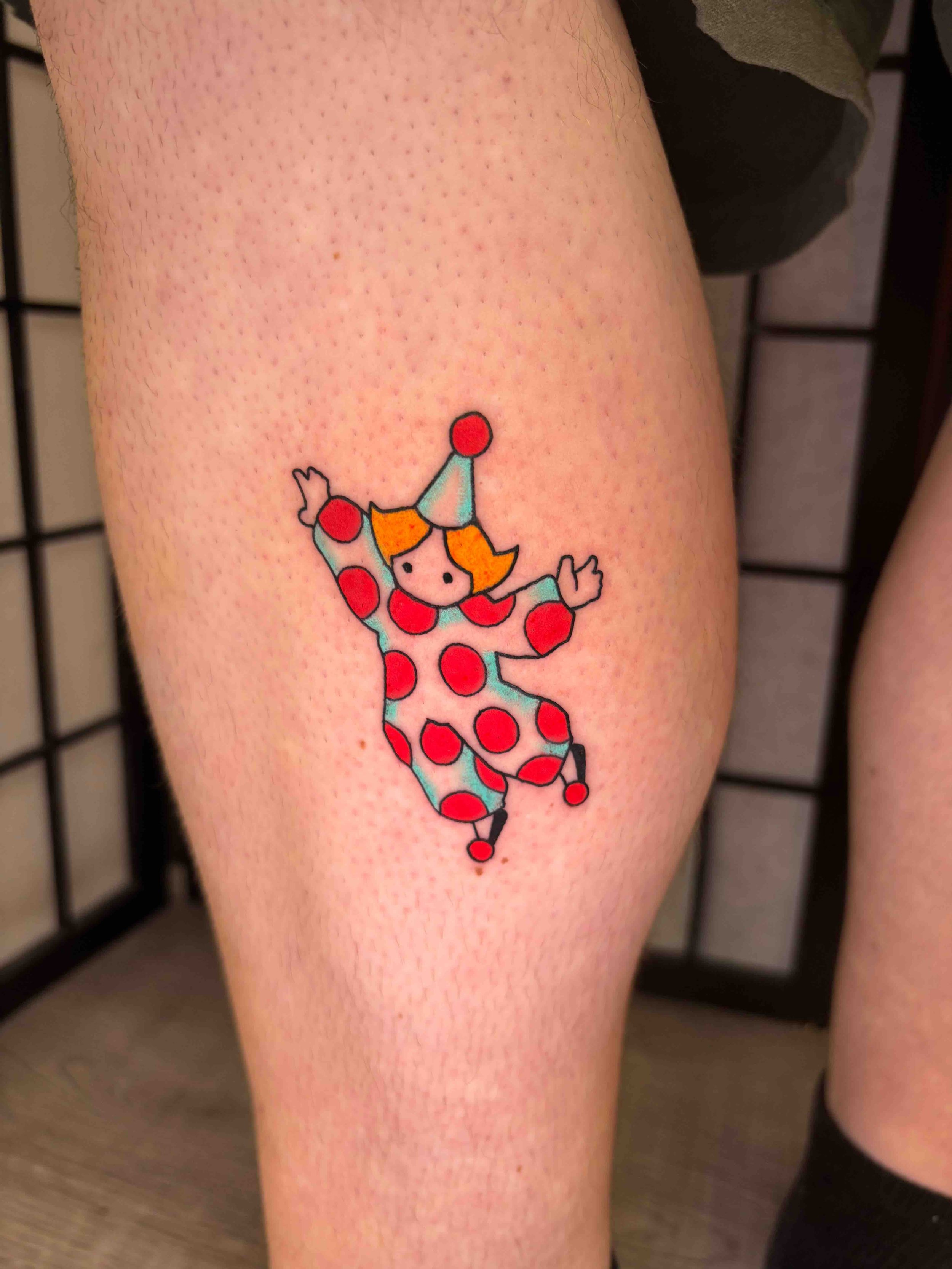 Neo traditional color clown tattoo on the inside of a calf, portfolio work by AK Zaionz at Sink or Swim in Niagara Falls NY