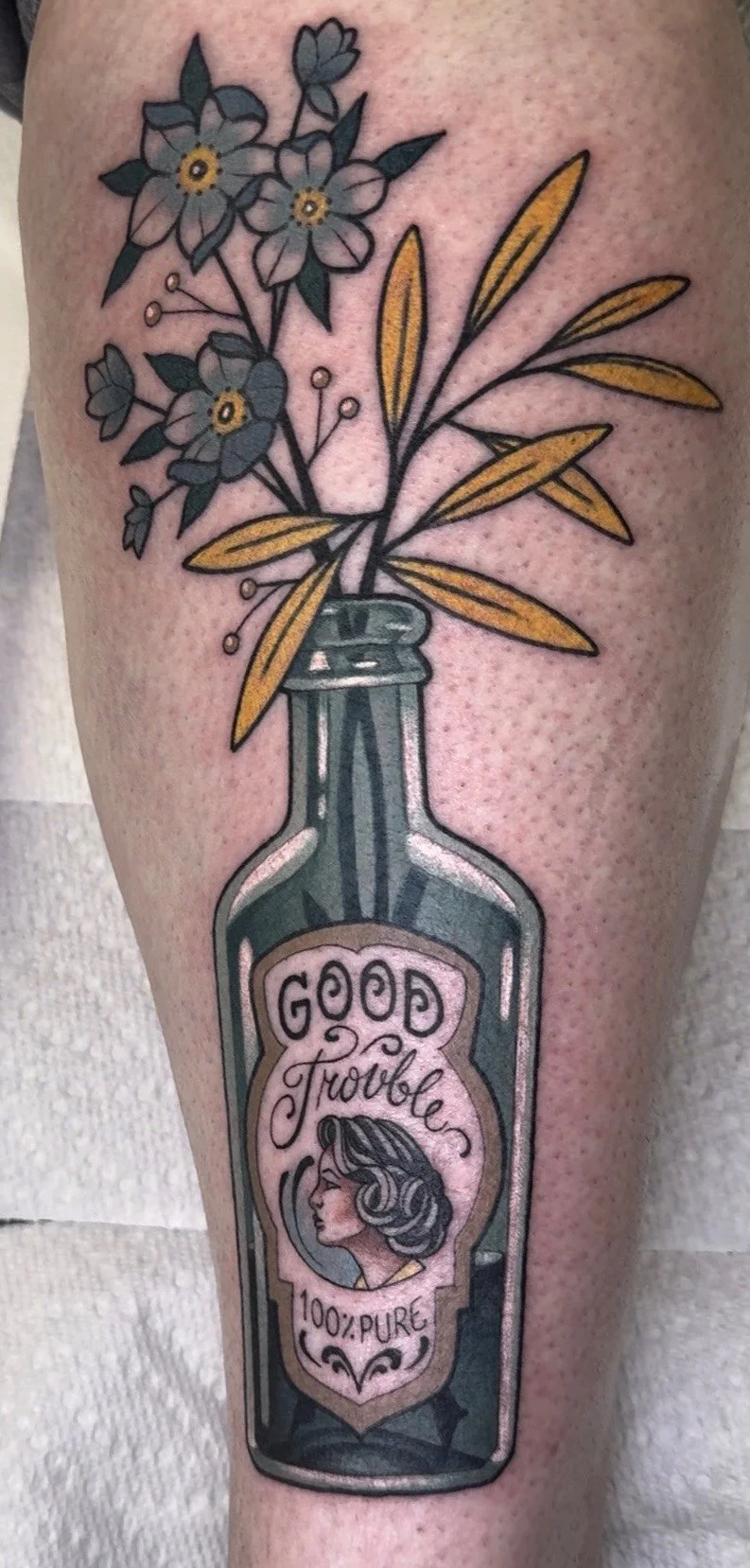 Neo traditional apothecary bottle holding stemmed flowers and leaves portfolio work by Keith Kuzara at Sink or Swim Tattoo and Piercing in Niagara Falls NY