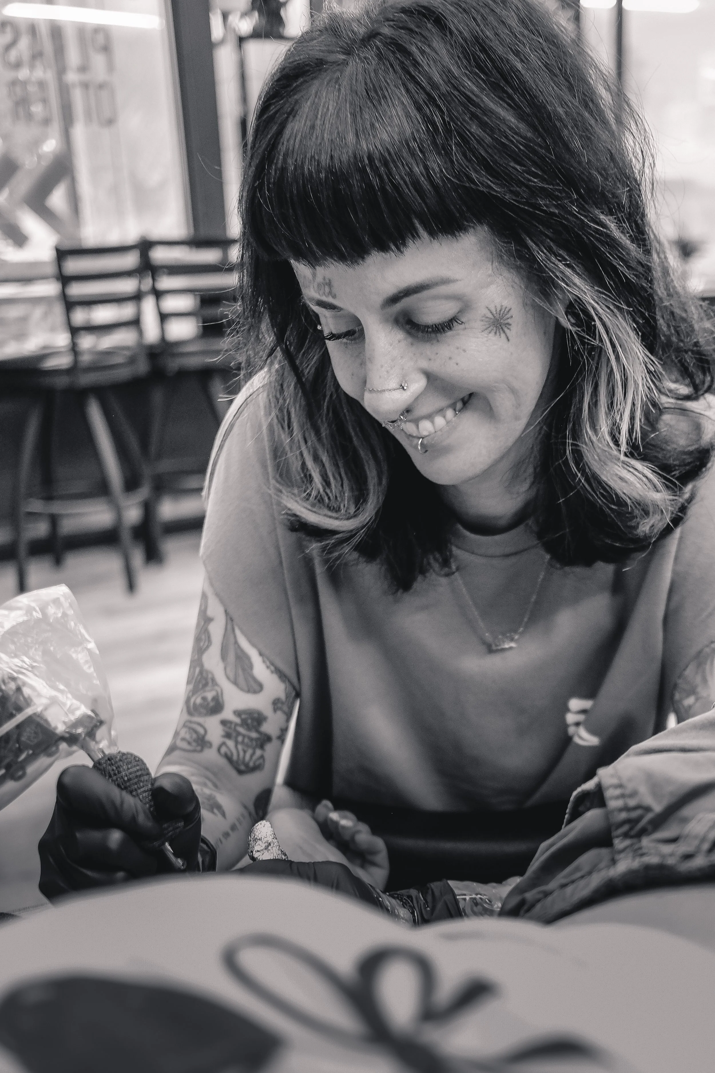 tattoo artist sam Sullivan working on a lithograph style tattoo at sink or swim in western New York