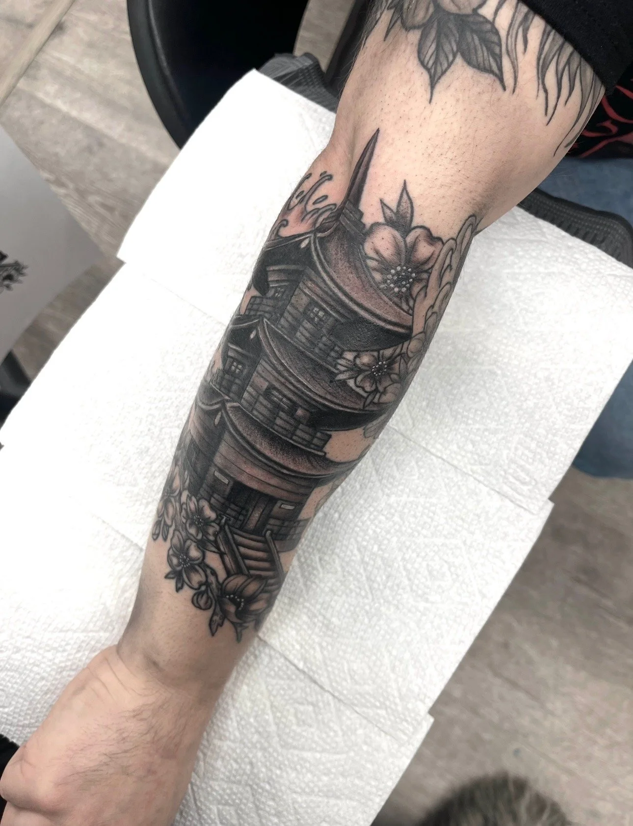 black and grey pagoda tattoo on forearm , portfolio work by Brooke Canzoneri at sink or swim tattoo and piercing in Niagara Falls, ny
