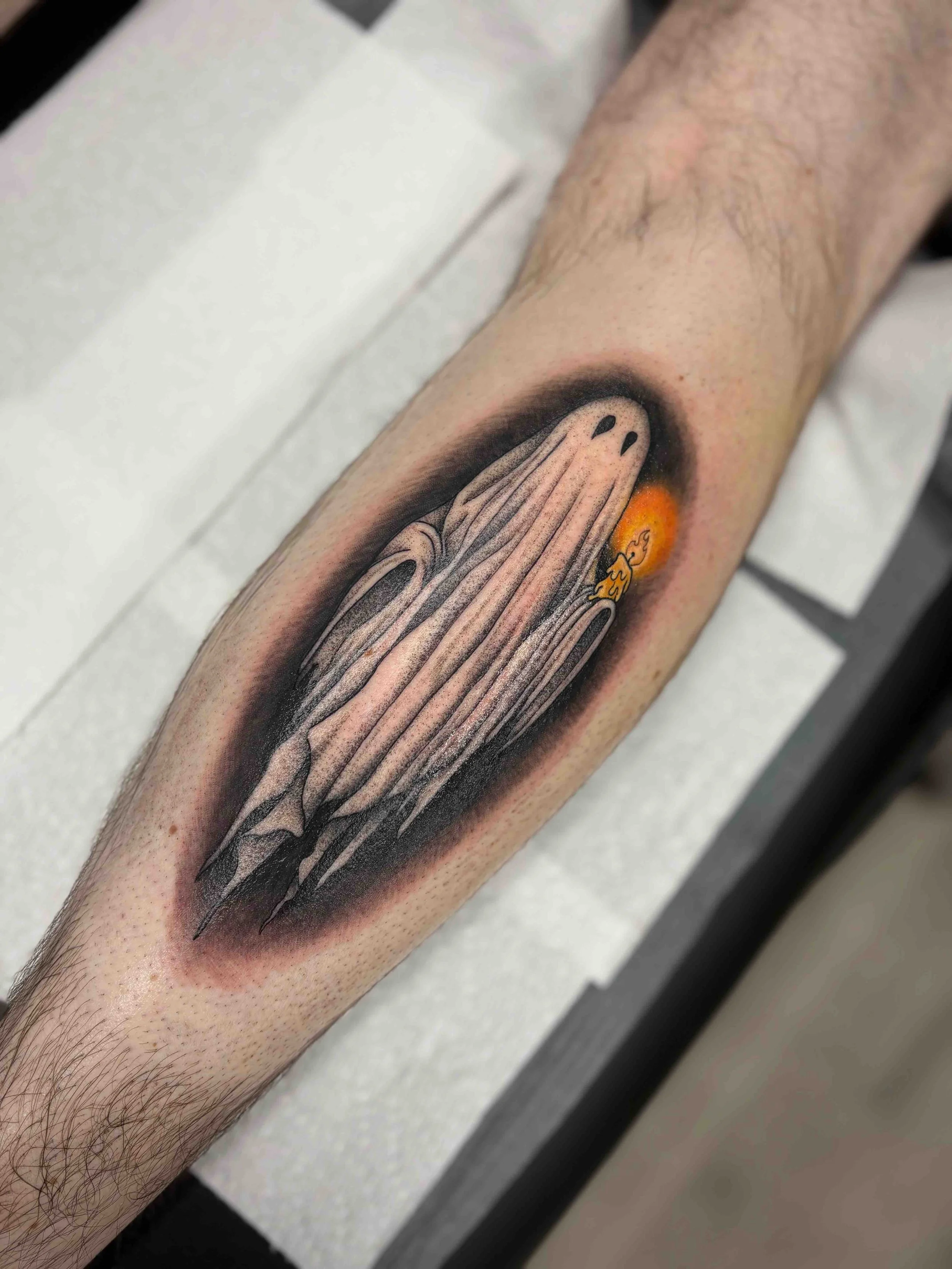 ghost holding candle on calf tattoo , portfolio work by Brooke Canzoneri at sink or swim tattoo and piercing in Niagara Falls, ny