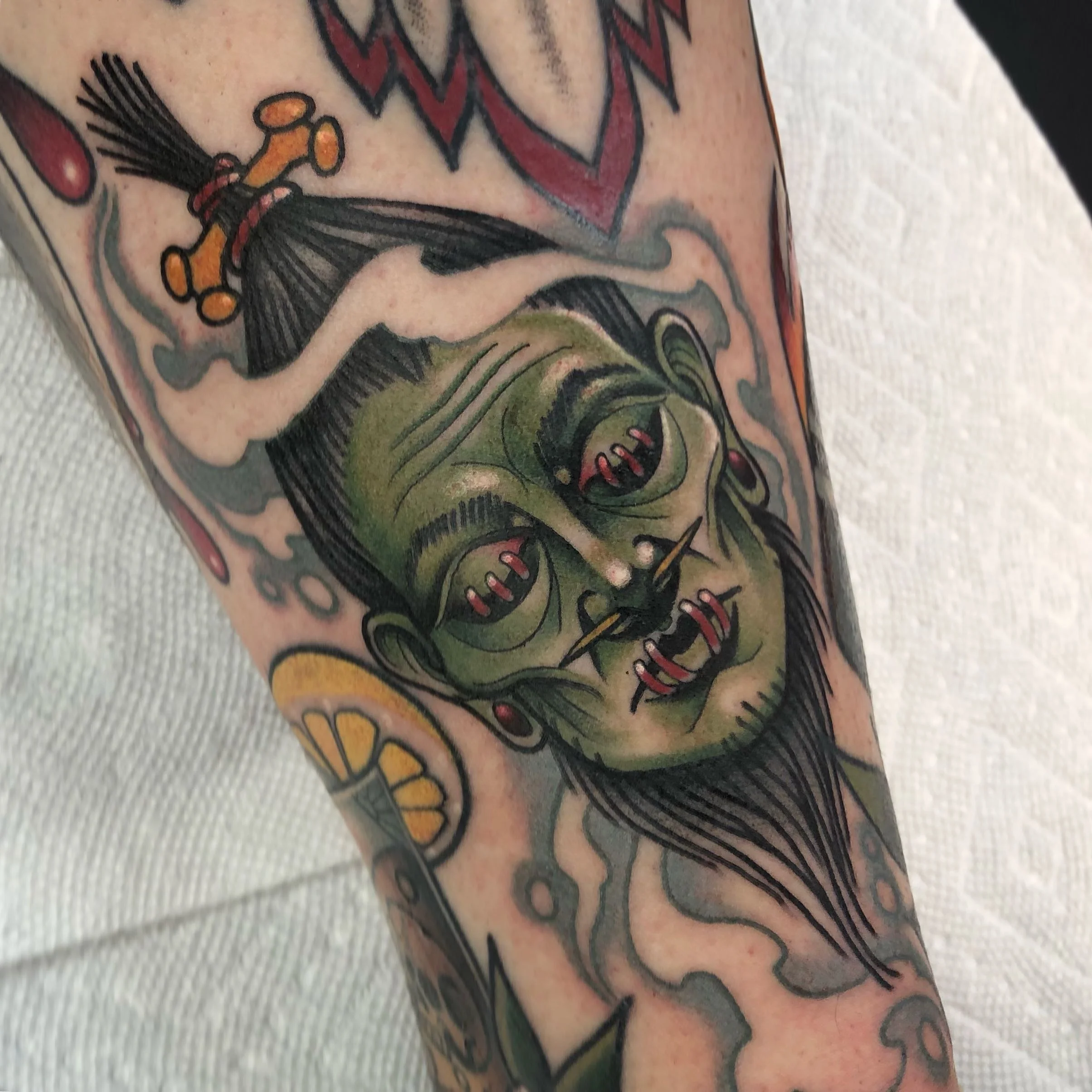 Neo traditional shrunken head color tattoo	portfolio work by Keith Kuzara at Sink or Swim Tattoo and Piercing in Niagara Falls NY