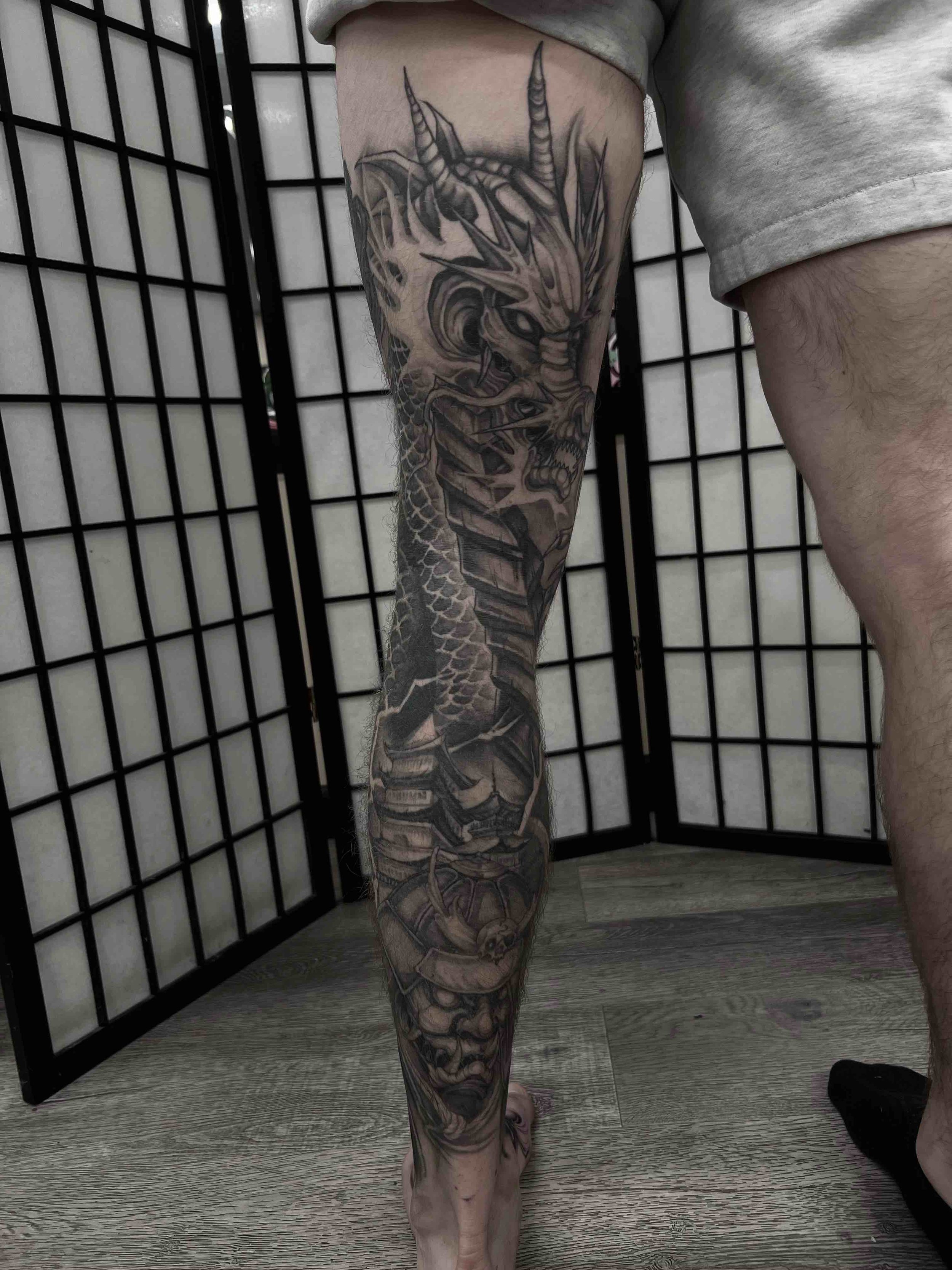dark art black and grey dragon and oni leg sleeve , portfolio work by Jordy Levea at sink or swim tattoo and piercing in Niagara Falls, ny