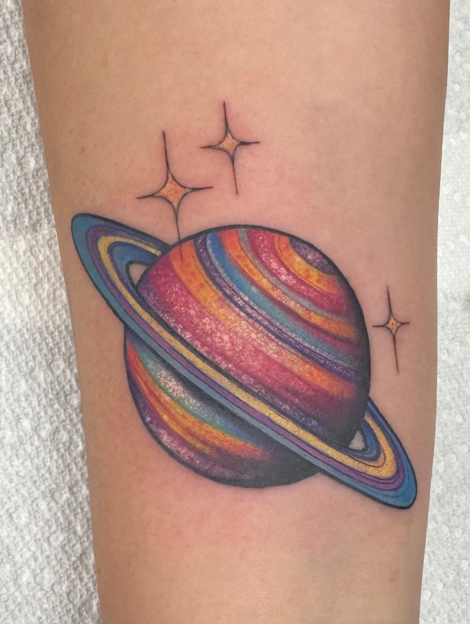 Neo traditional planet saturn space tattoo in color portfolio work by Shannon Kuzara at Sink or Swim Tattoo and Piercing in Niagara Falls NY