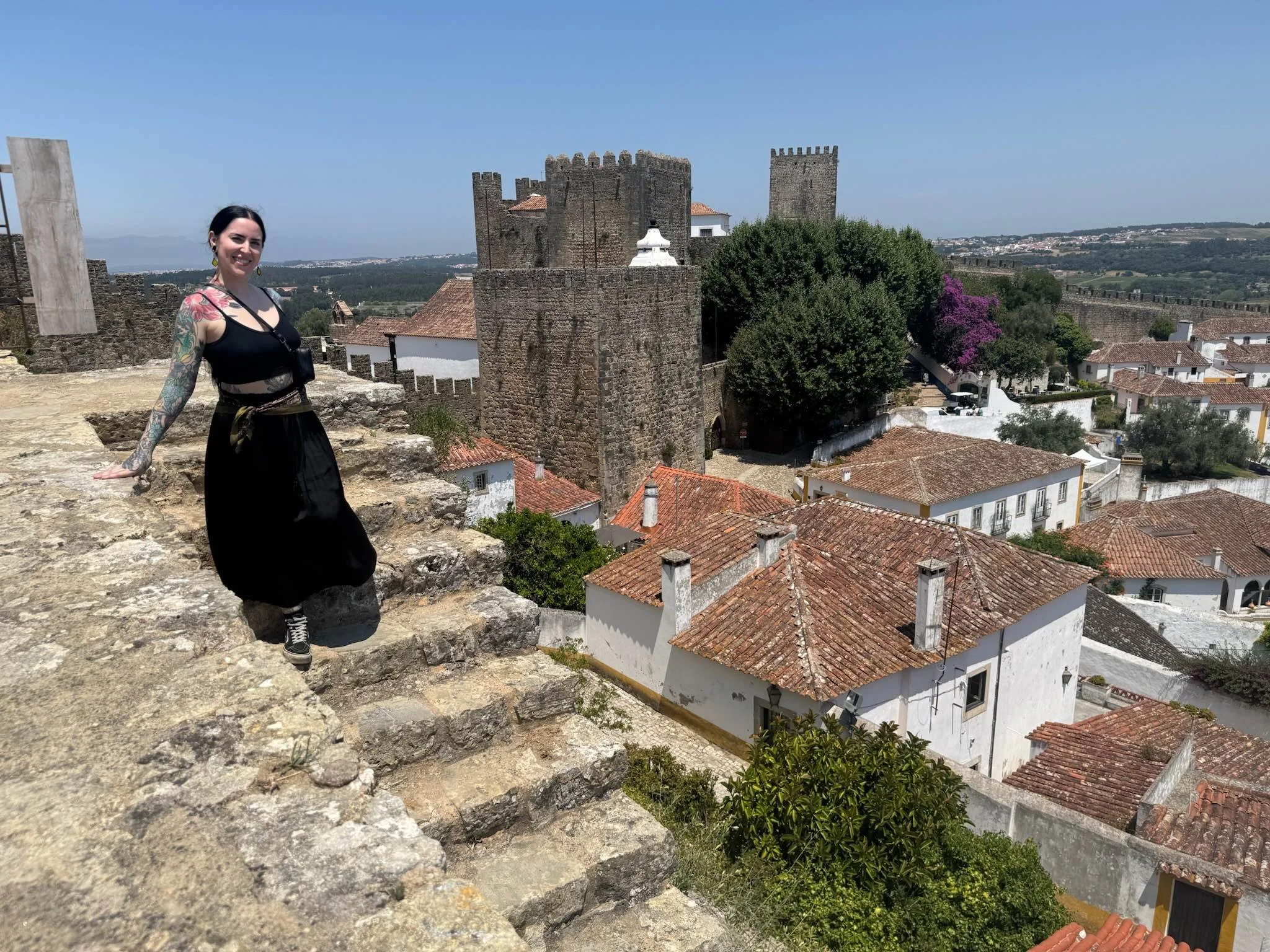 Shannon posing at the stairs in obidos in Portugal