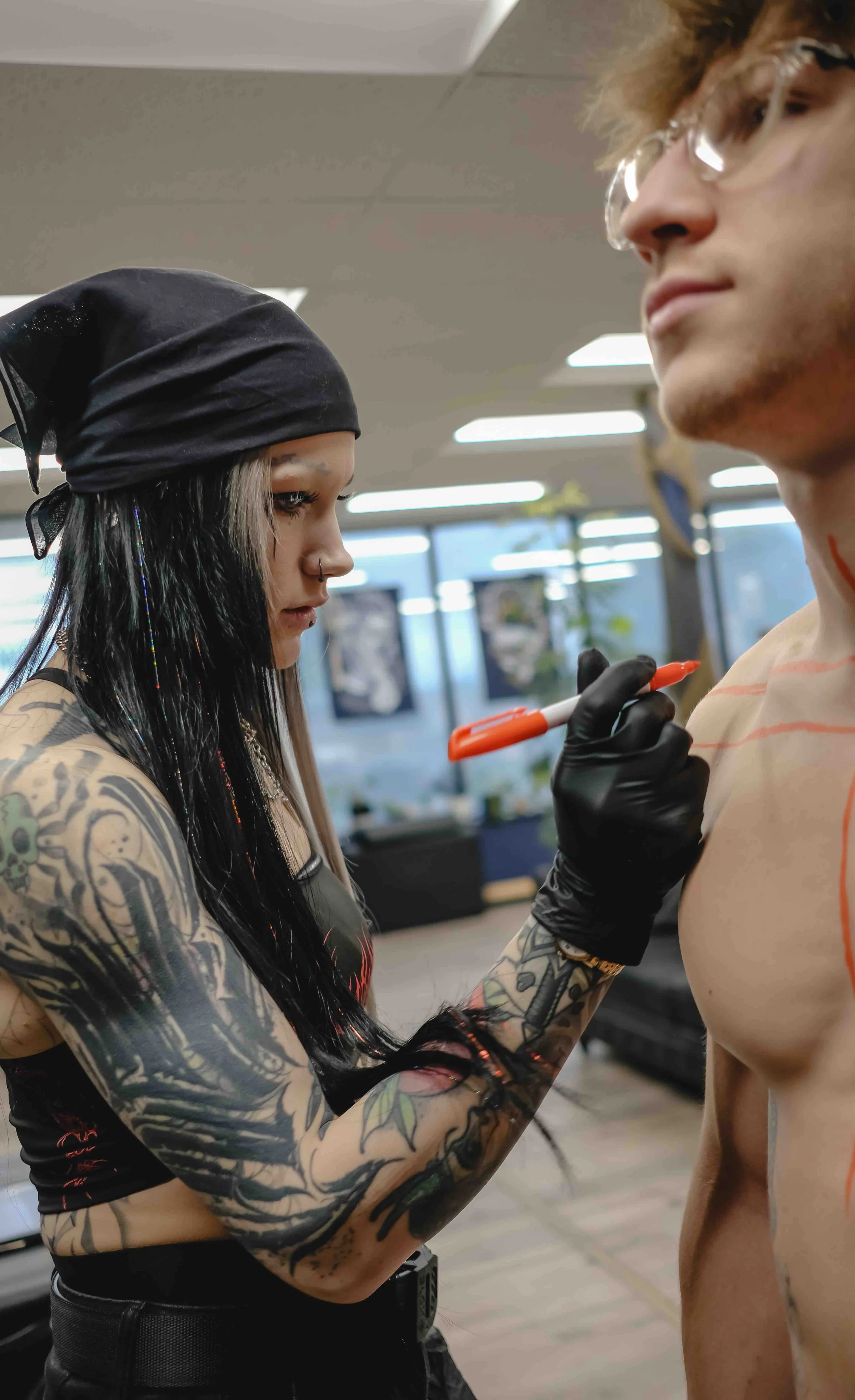 Jordy placing a stencil for a tattoo at sink or swim tattoo and piercing