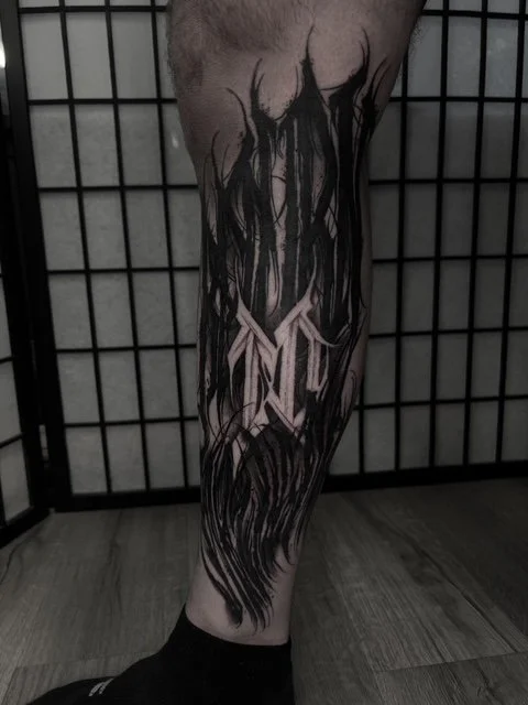 dark art lettering leg tattoo , portfolio work by Jordy Levea at sink or swim tattoo and piercing in Niagara Falls, ny