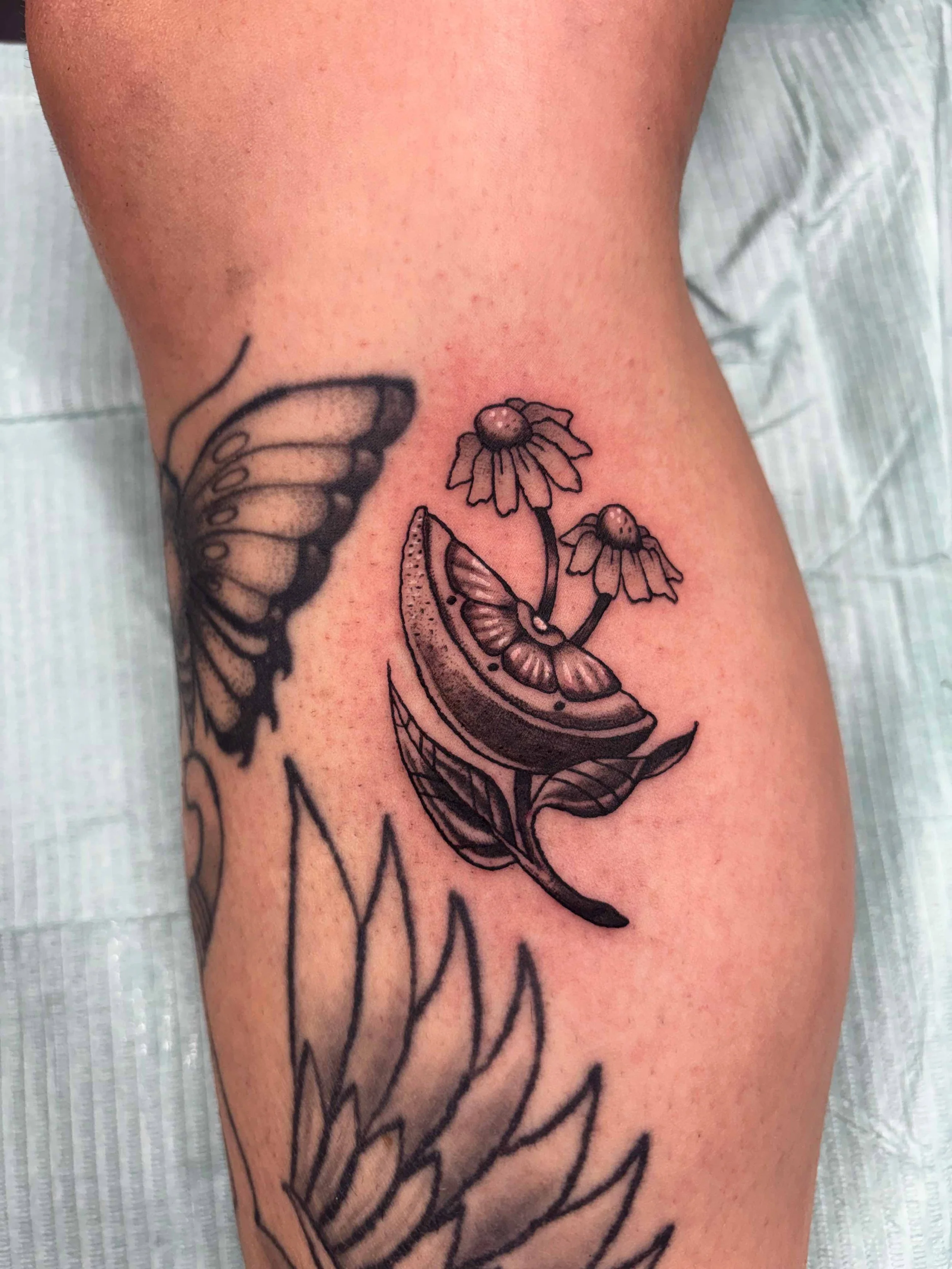 Black and grey lemon with chamomile herbal tattoo by AK Zaionz at Sink or Swim in Niagara Falls NY