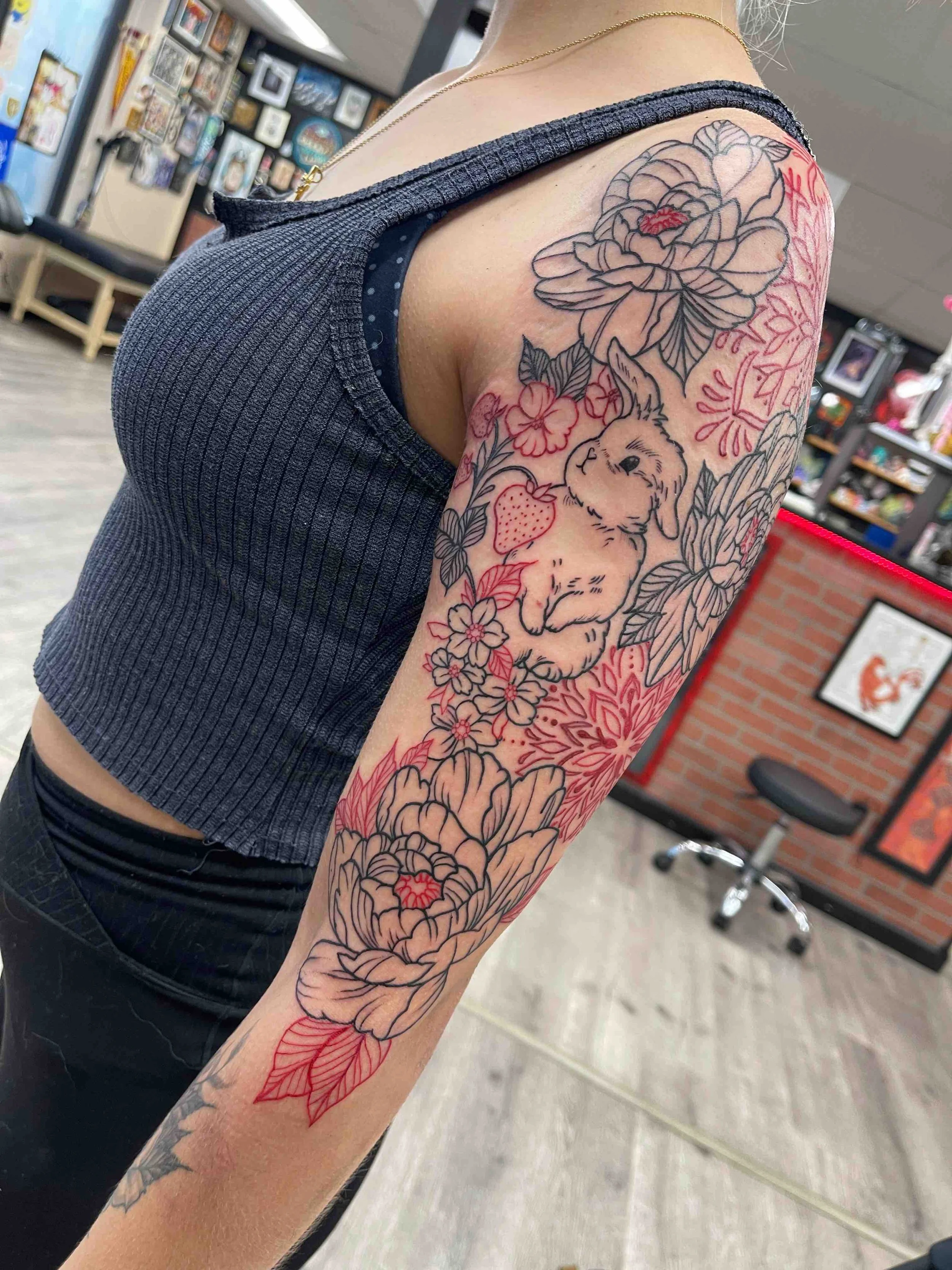 black and red line work, illustrative tattoo sleeve on arm , portfolio work by Brooke Canzoneri at sink or swim tattoo and piercing in Niagara Falls, ny