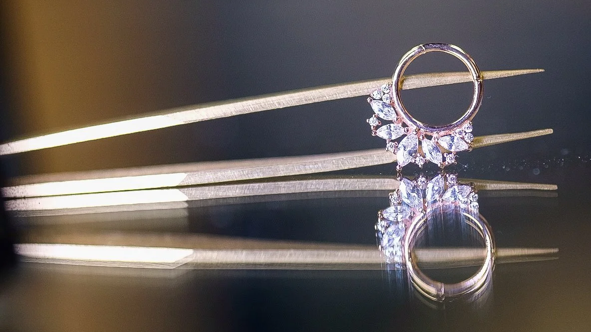 close up of solid gold 18k septum ring at the jewelry counter of sink os swim tattoo and piercing in Niagara Falls New York