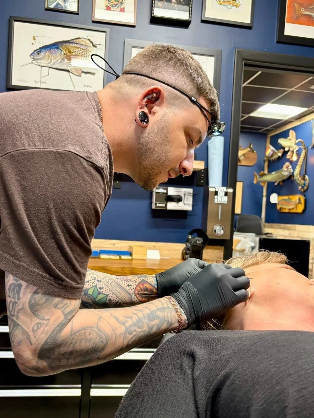 ggy Luppino performing a daith piercing at Sink or Swim Tattoo and Piercing in Niagara Falls, NY