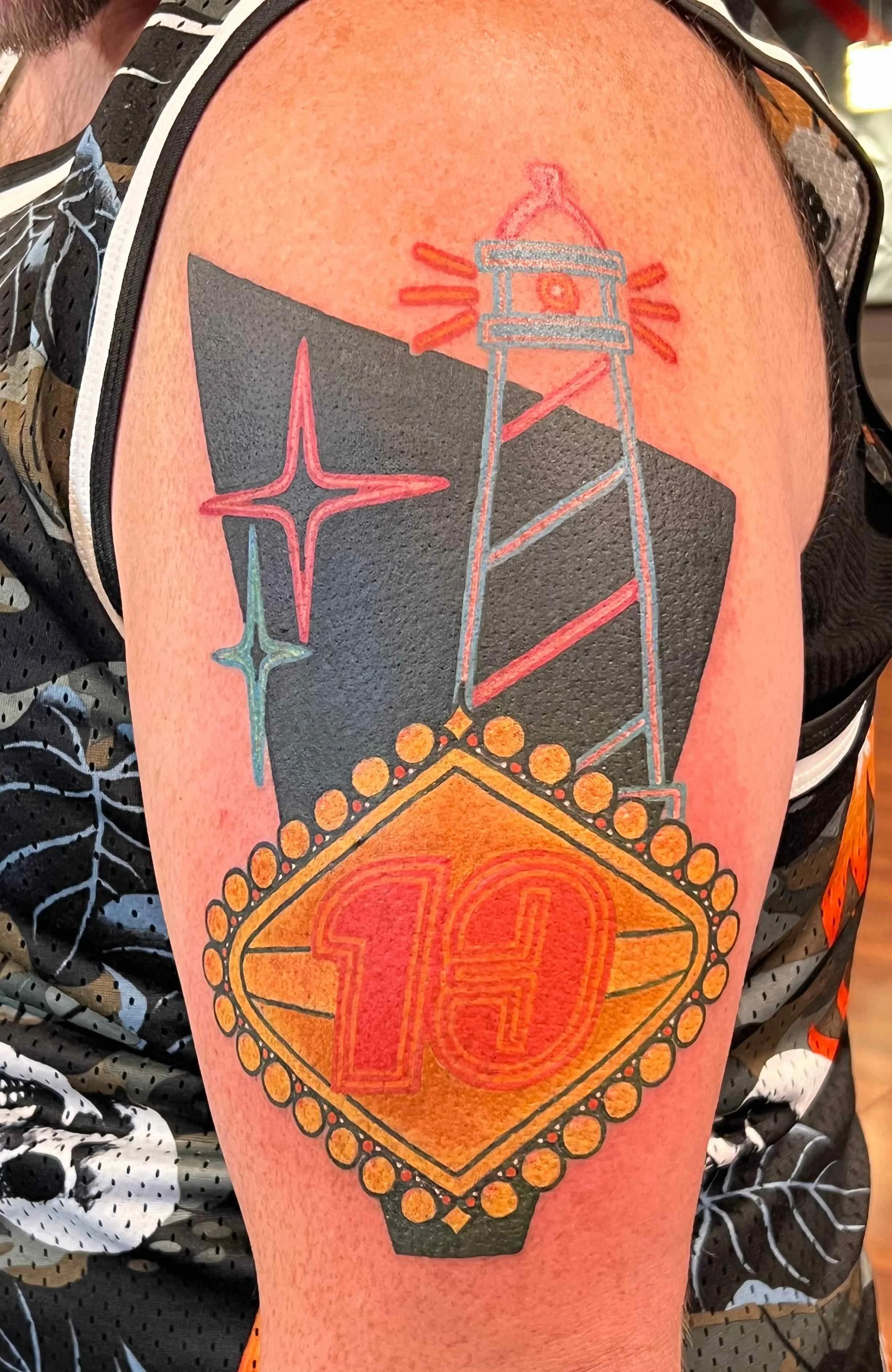 traditional style lighthouse and Vegas sign arm tattoo, portfolio work by Sam Sullivan at Sink or Swim Tattoo and Piercing in Niagara Falls, NY