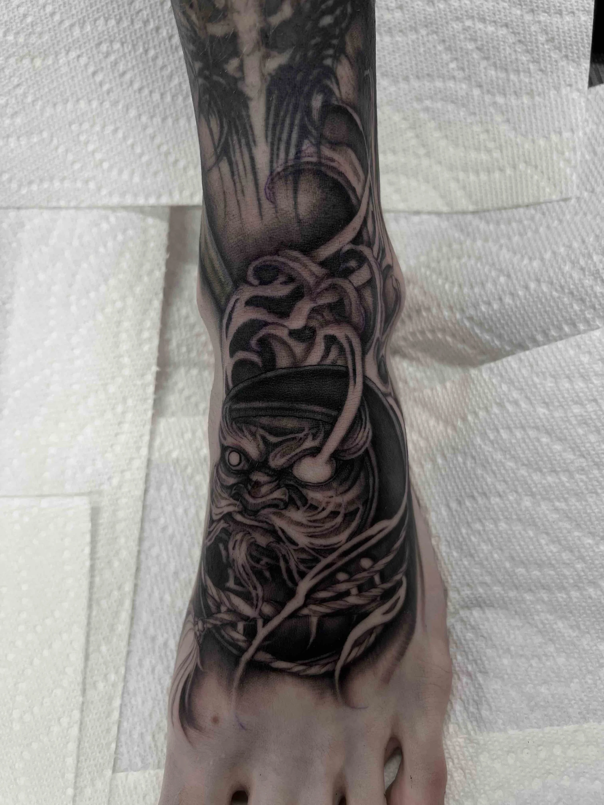 dark art black and grey drama doll foot tattoo , portfolio work by Jordy Levea at sink or swim tattoo and piercing in Niagara Falls, ny
