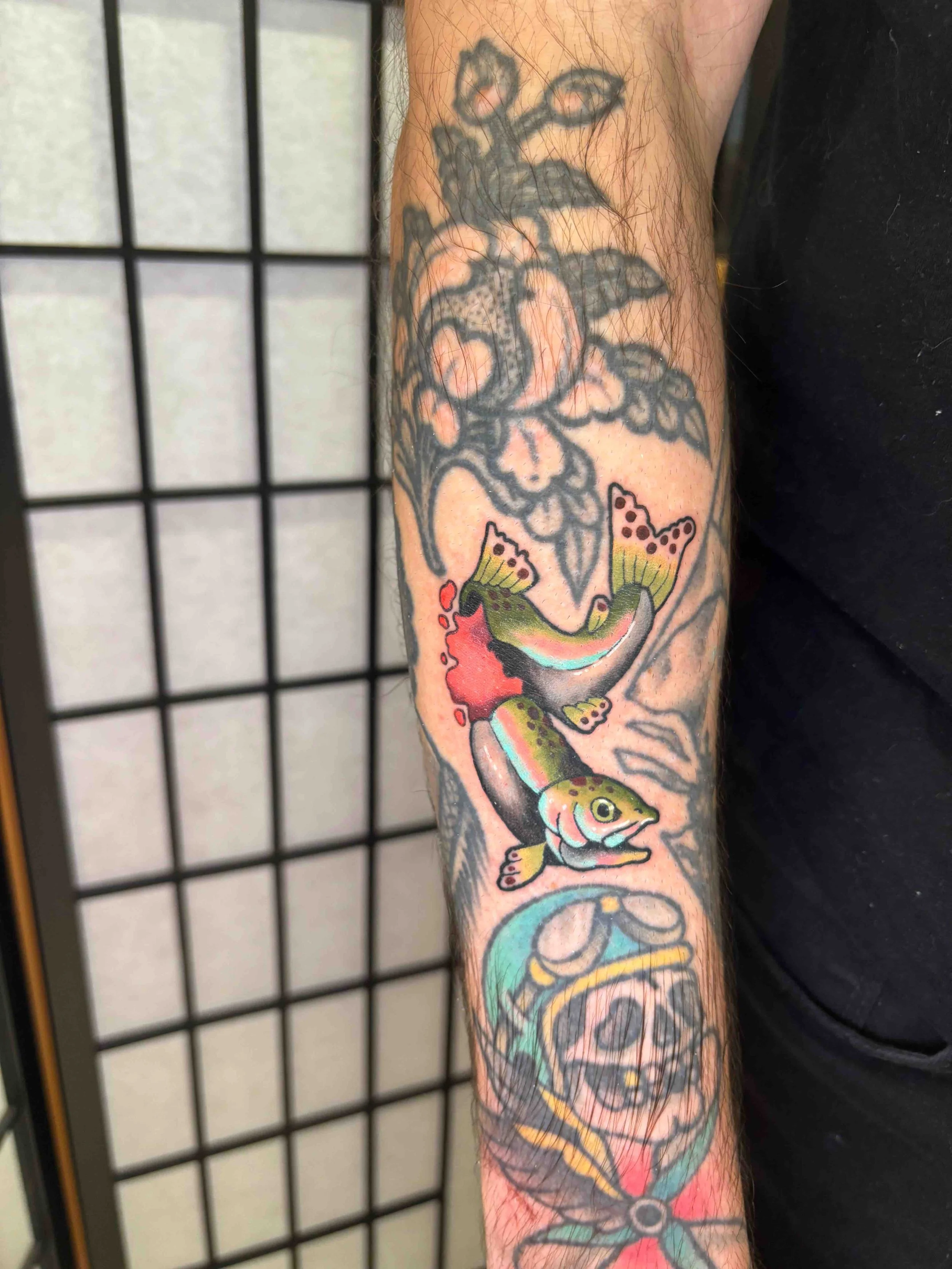 Neo traditional color rainbow trout fish tattoo on a forearm, portfolio work by AK Zaionz at Sink or Swim in Niagara Falls NY