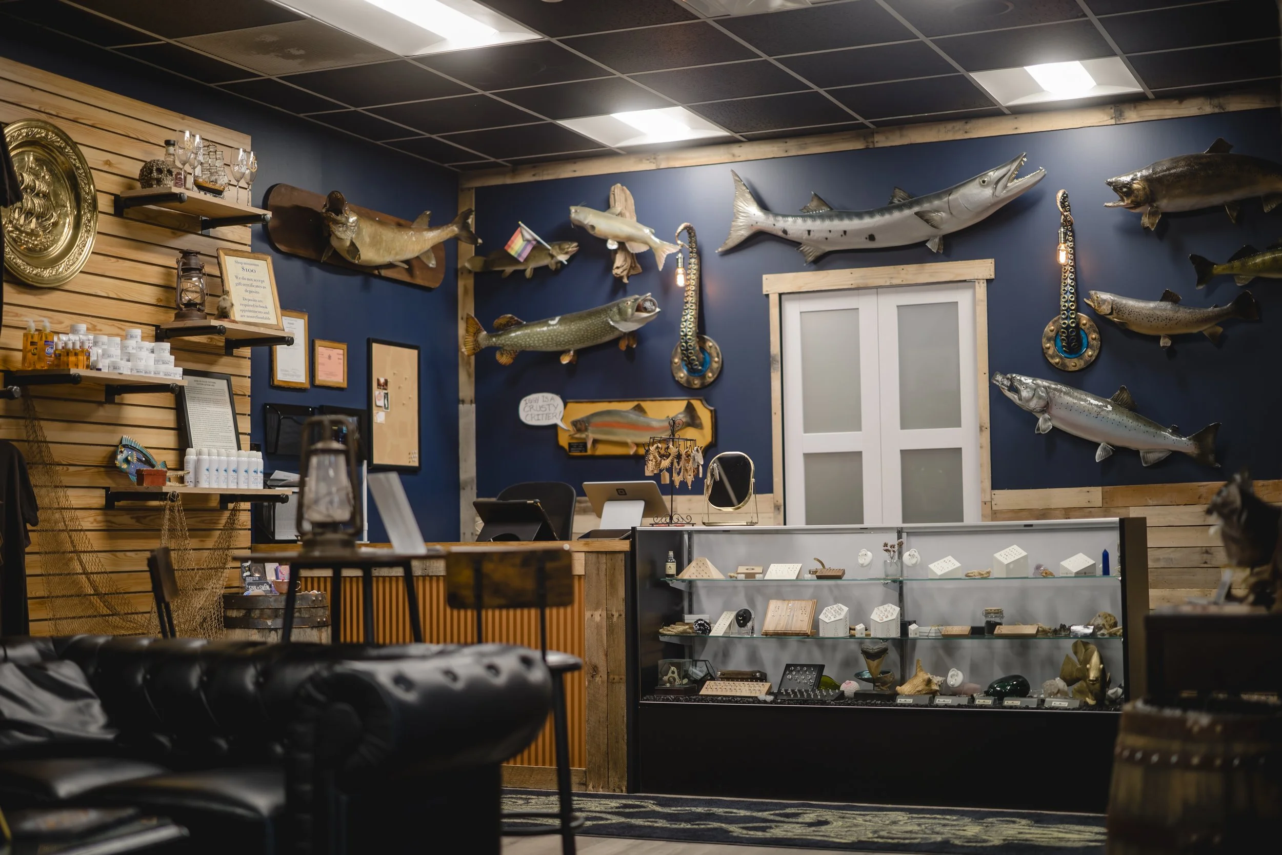 The retail counter and jewelry display case featuring implant-grade titanium body jewelry inside Sink or Swim Tattoo and Piercing studio near Buffalo NY