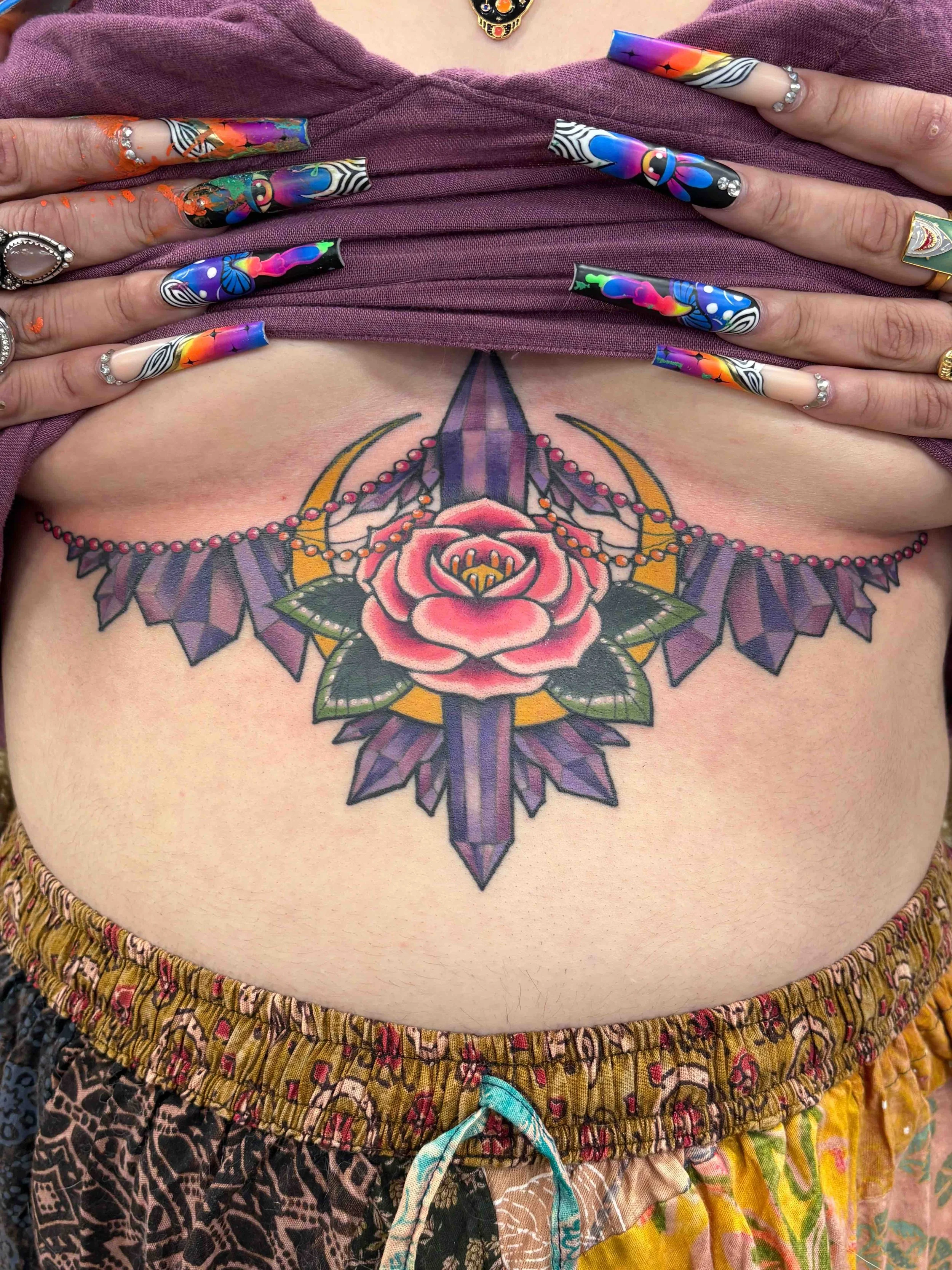 chest and under breast tattoo of ornamental work with a flower and moon, portfolio work by Samantha Sullivan at Sink or Swim Tattoo and Piercing in Niagara Falls, NY
