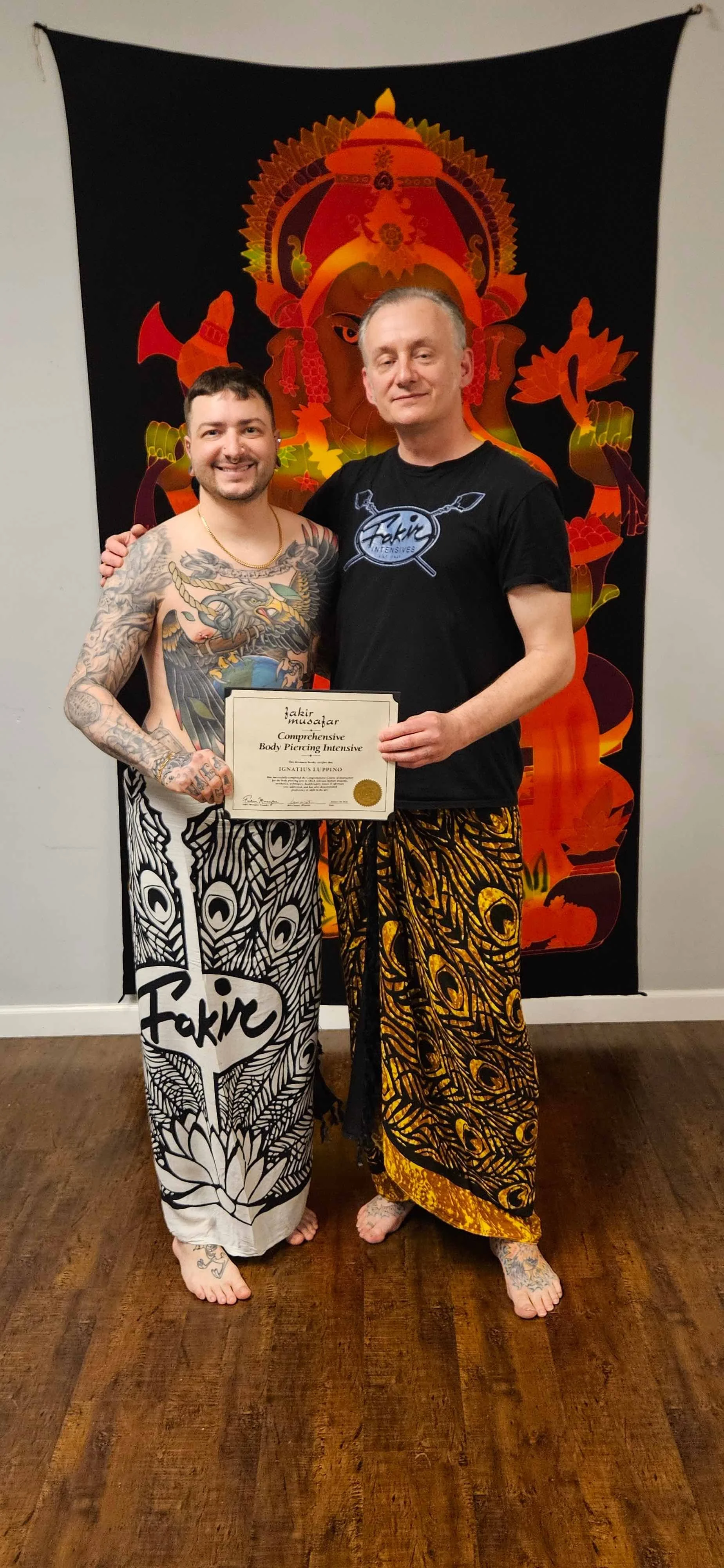 piercer Iggy Luppino standing with instructor at fakir institute receiving his diploma for the comprehensive piercing course for intermediate piercers