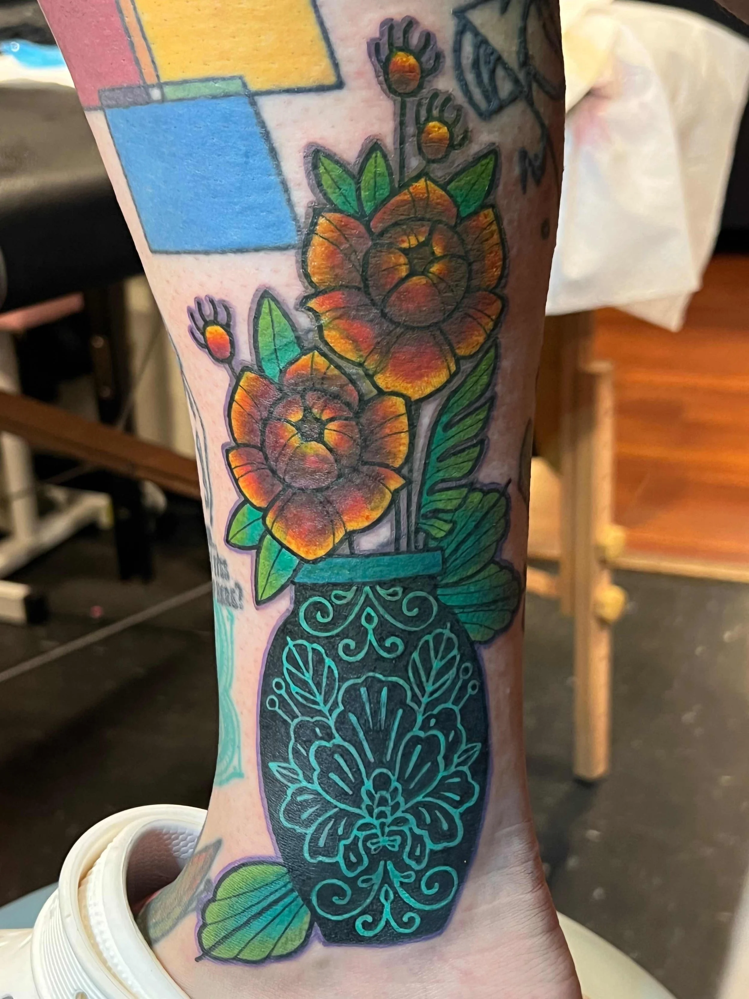 flower pot and flowers cover up on a leg done by Samantha Sullivan at Sink or Swim Tattoo and Piercing in Niagara Falls, NY