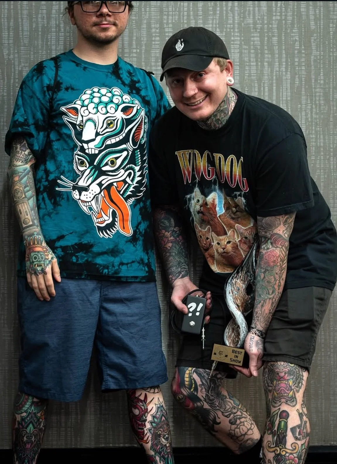 Keith holding a best of show trophy from the flower city tattoo convention