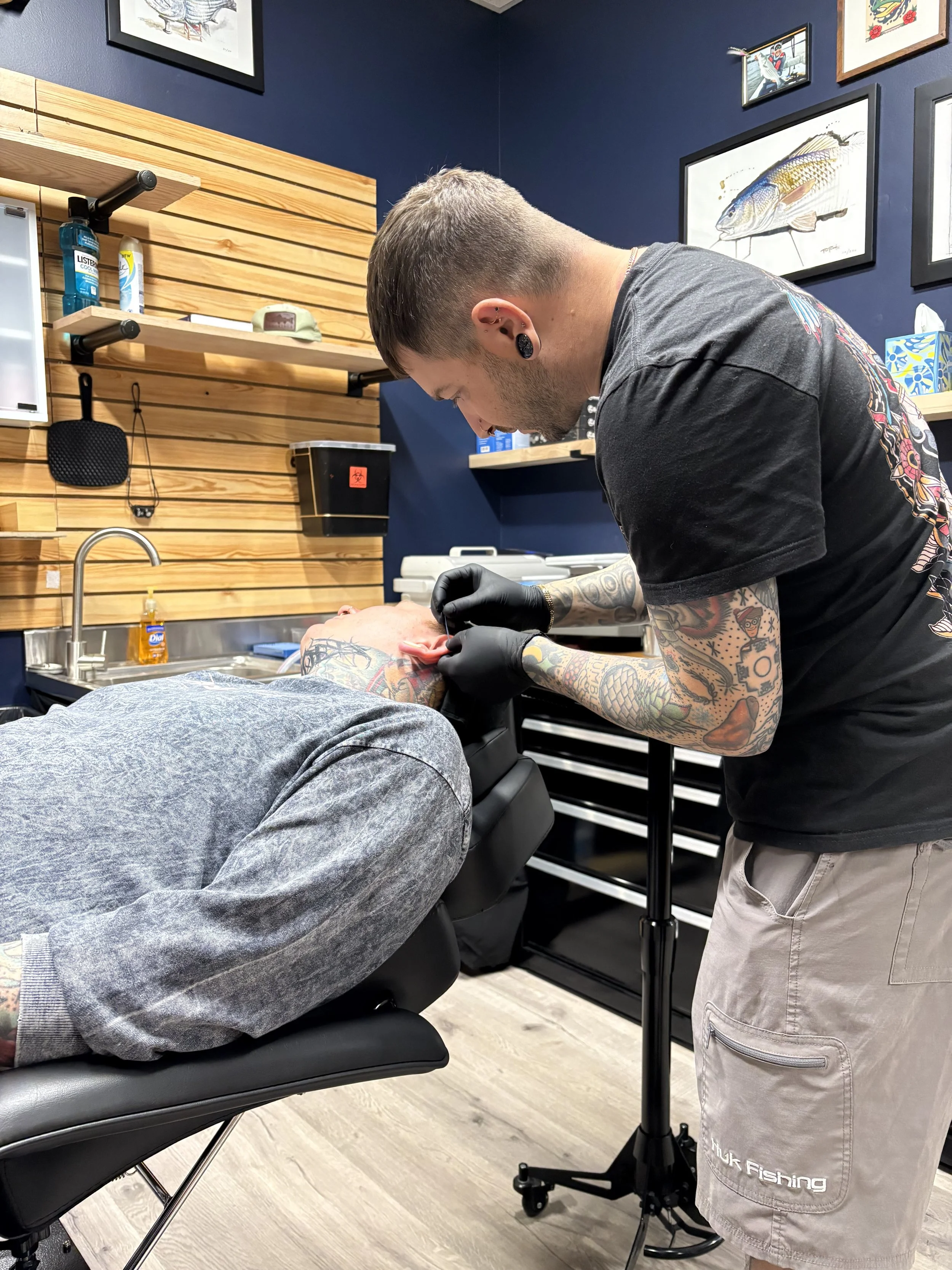 Iggy Luppino performing an ear cartilage piercing at Sink or Swim Tattoo and Piercing in Niagara Falls, NY