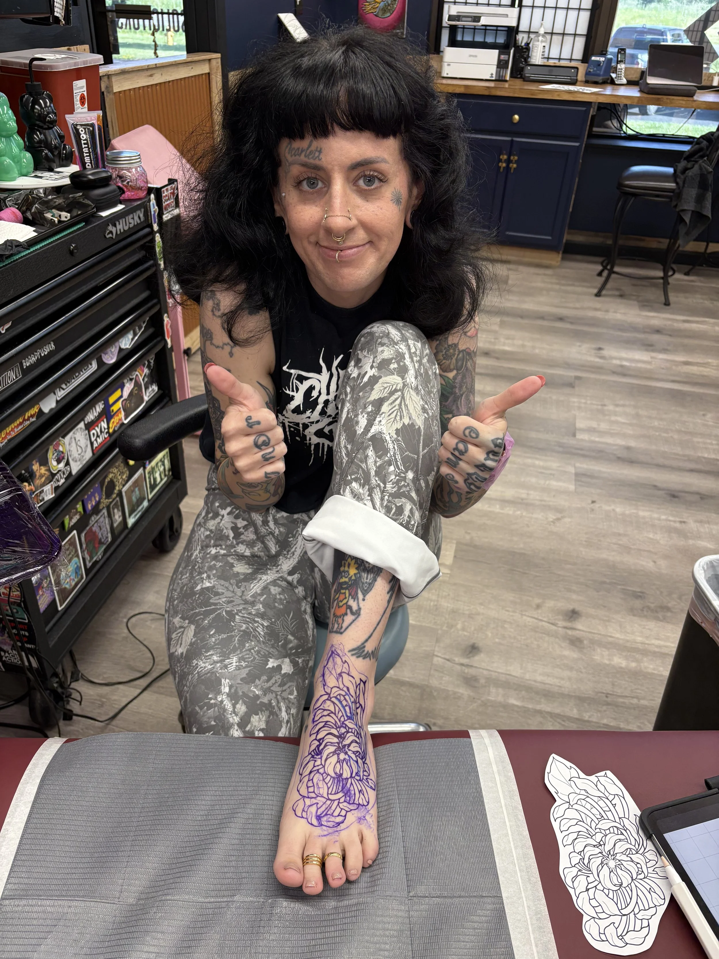 Samantha Sullivan tattooing her own foot at Sink or Swim in Niagara Falls, NY