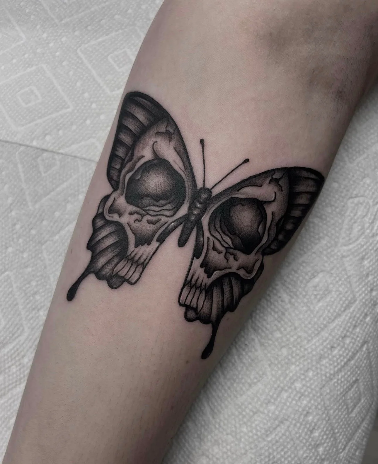 black and grey butterfly tattoo with skull , portfolio work by Brooke Canzoneri at sink or swim tattoo and piercing in Niagara Falls, ny