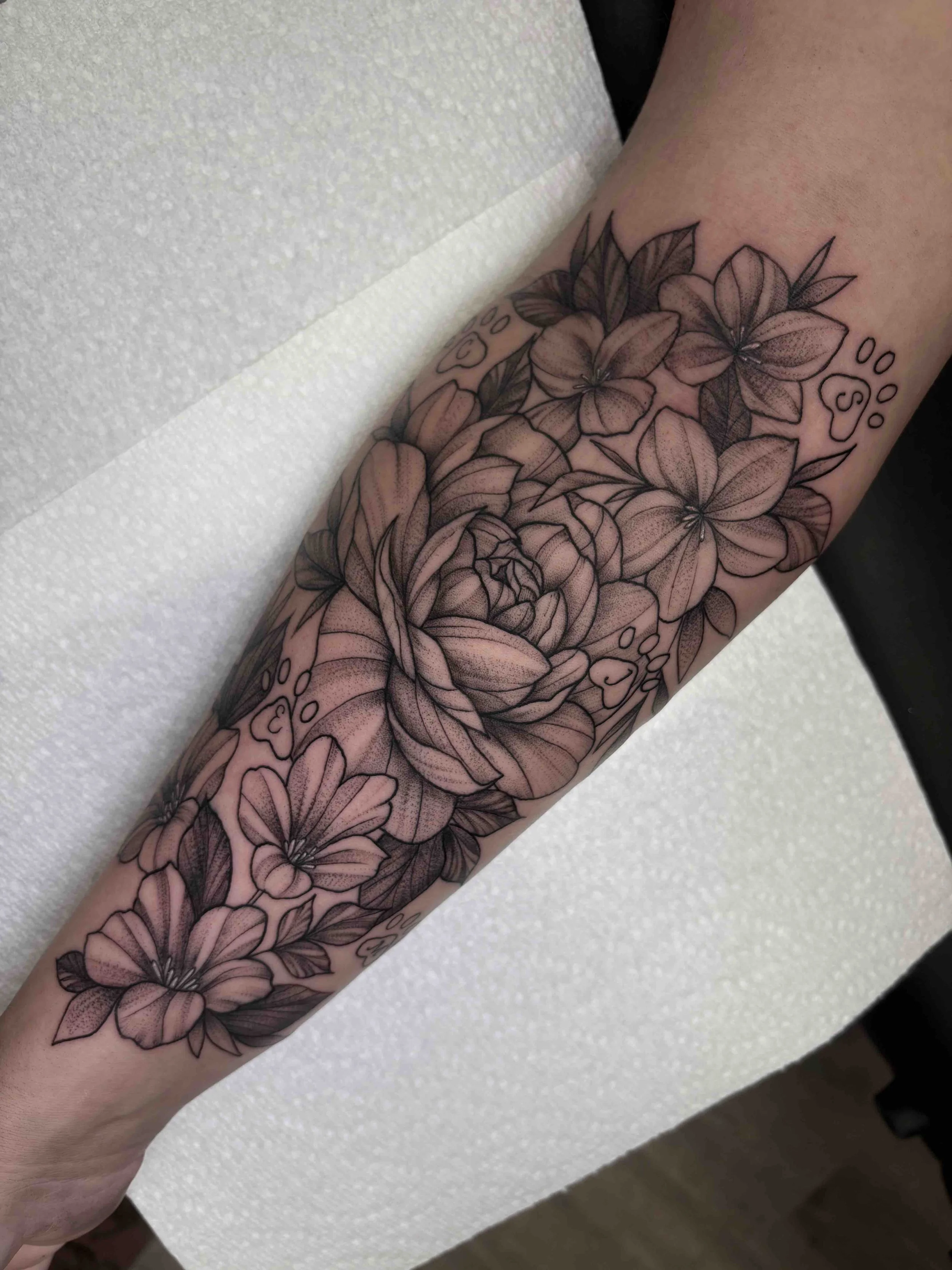 floral tattoo with peony on forearm, black and grey , portfolio work by Brooke Canzoneri at sink or swim tattoo and piercing in Niagara Falls, ny