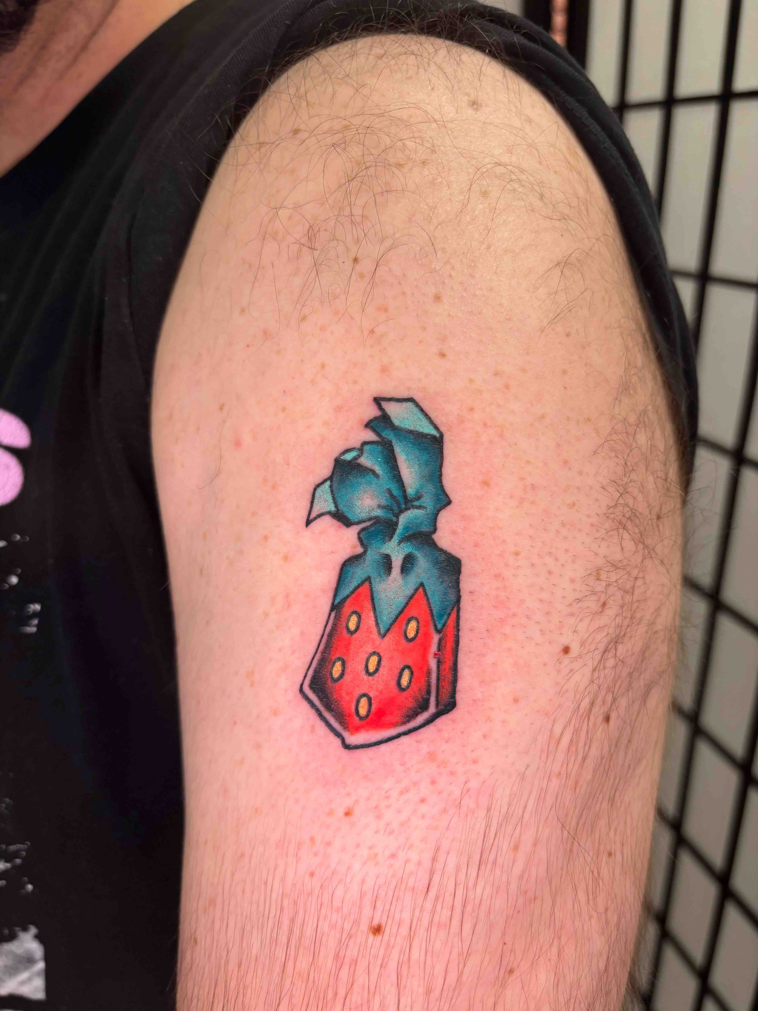American Traditional strawberry candy color tattoo on the shoulder, portfolio work by AK Zaionz at Sink or Swim in Niagara Falls NY