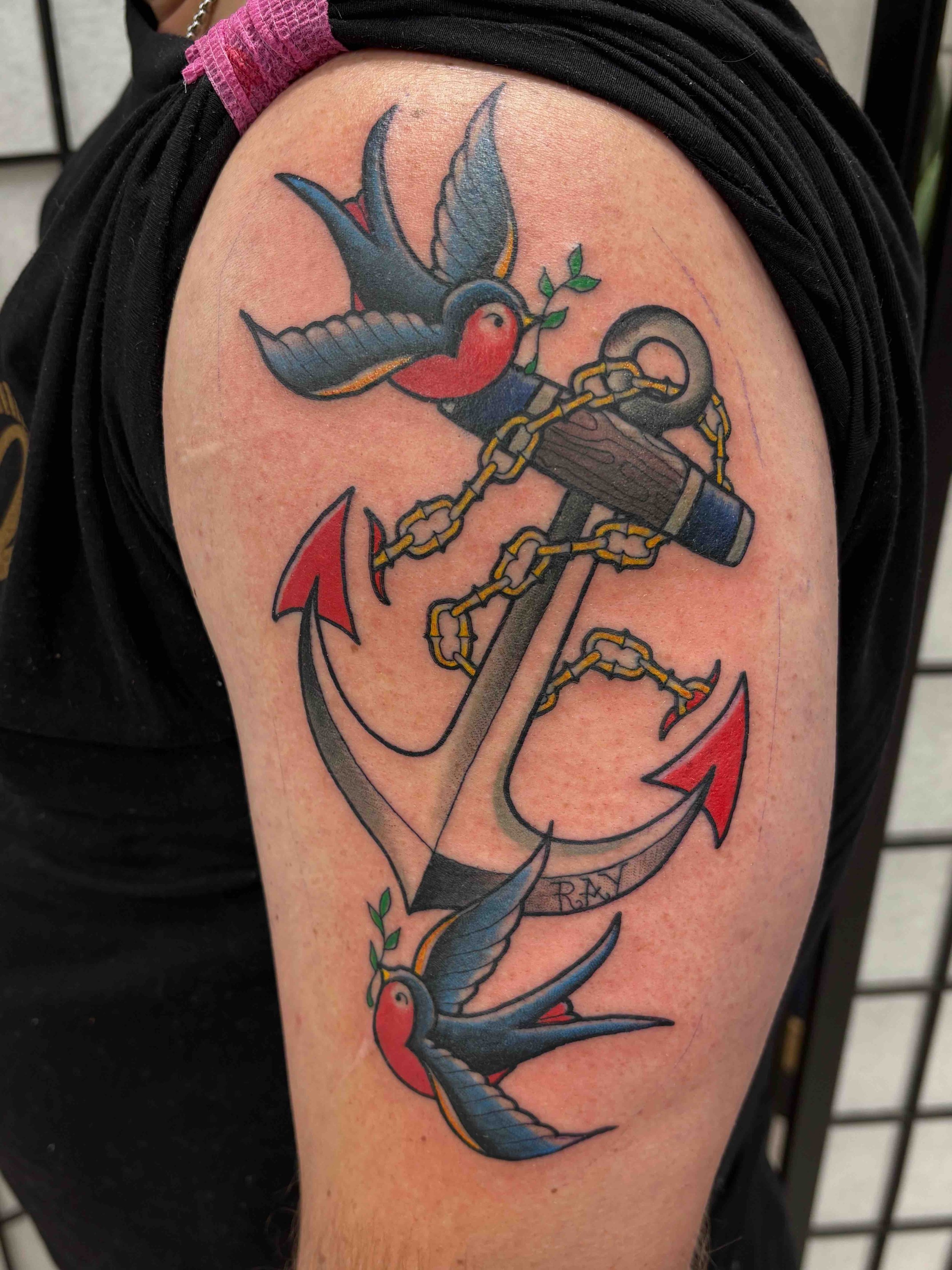 textbook traditional style anchor and swallows on an arm, portfolio work by Samantha Sullivan at Sink or Swim Tattoo and Piercing in Niagara Falls, NY
