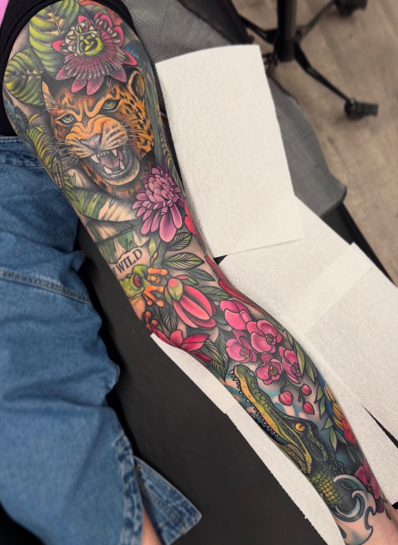 Neo traditional jungle creatures leg sleeve with flowers tattoo in color portfolio work by Shannon Kuzara at Sink or Swim Tattoo and Piercing in Niagara Falls NY