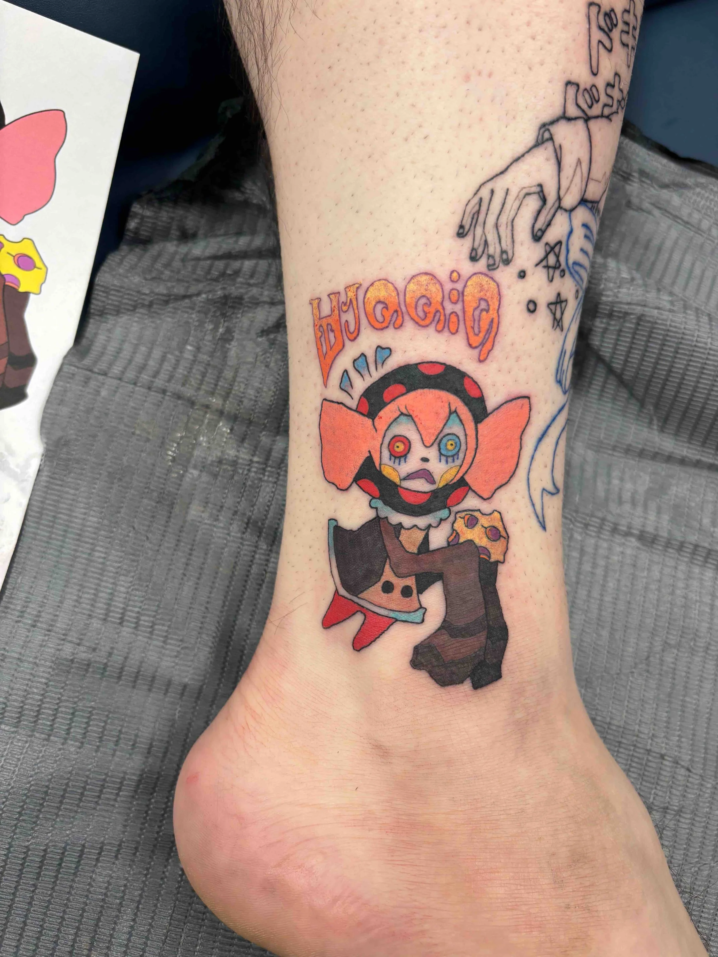 Color anime tattoo of Bebe from Madoka Magica on ankle, portfolio work by AK Zaionz at Sink or Swim in Niagara Falls NY