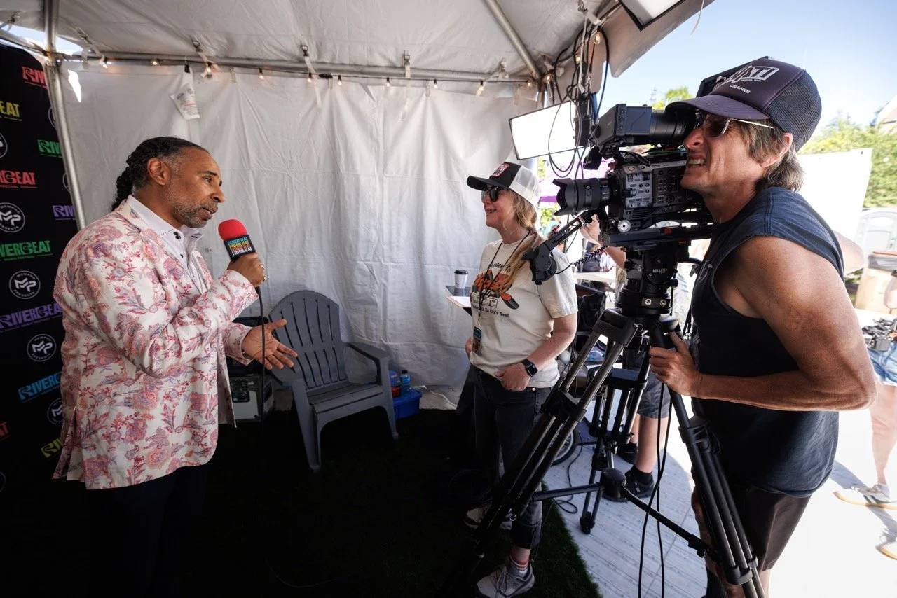 Memphis producer Boo Mitchell answers a question from director Savannah Bearden while Brent Shrewsbury films the interview at RiverBeat Music Fest 2026. Tom Lee Park, Memphis.