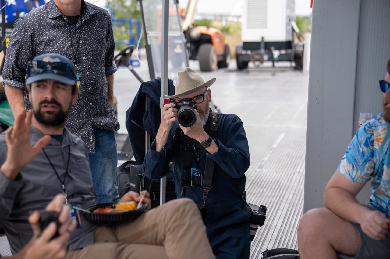 Photographer Jamie Harmon shooting in the backstage hospitality area at RiverBeat Music Fest 2026 for agency. Tom Lee Park, Memphis.