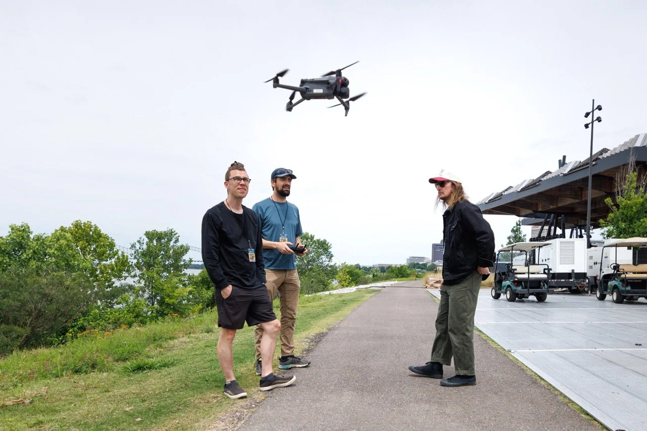 Drone operator Peter Braswell, B-roll DP David Roseberry, and EP Benjamin Rednour launching the drone at RiverBeat Music Fest 2026. Tom Lee Park, Memphis.