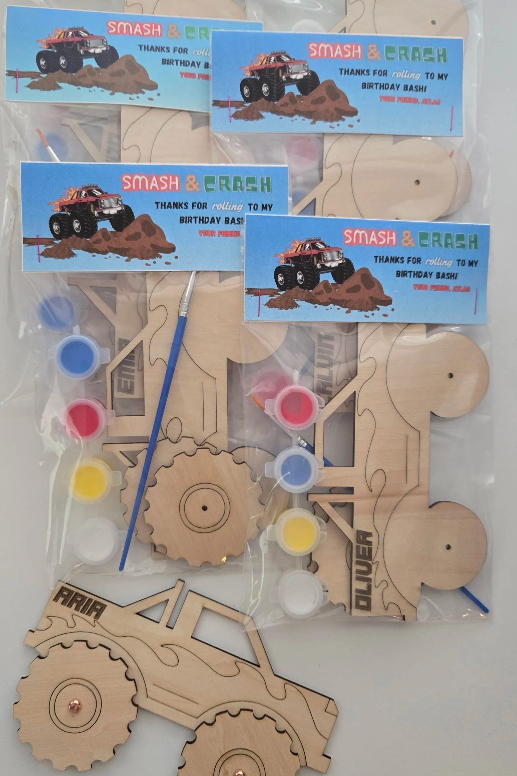 Bags of painting kits containing monster trucks with paint and paintbrush