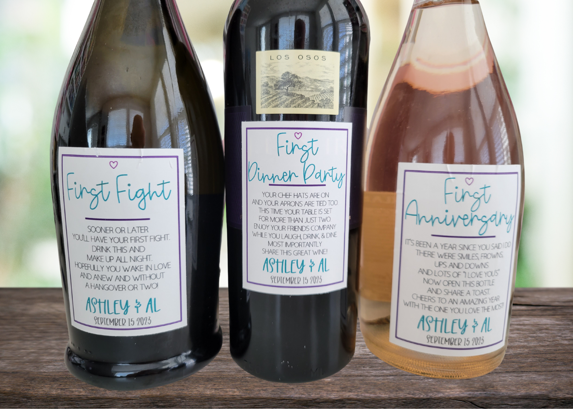 Three wine bottles with custom labels for a couple's milestones: First Fight, First Dinner Party, and First Anniversary