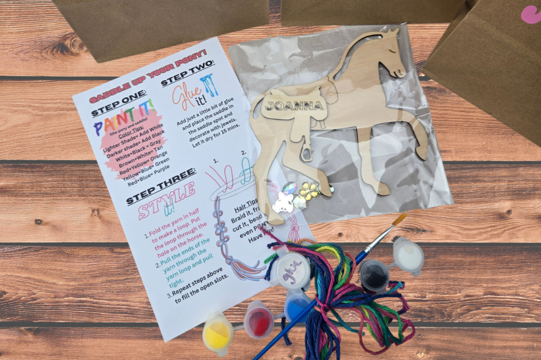 Horse paint kit with a wooden horse personalized with a name, paint pots, a brush, colorful string for the mane, and an instruction card
